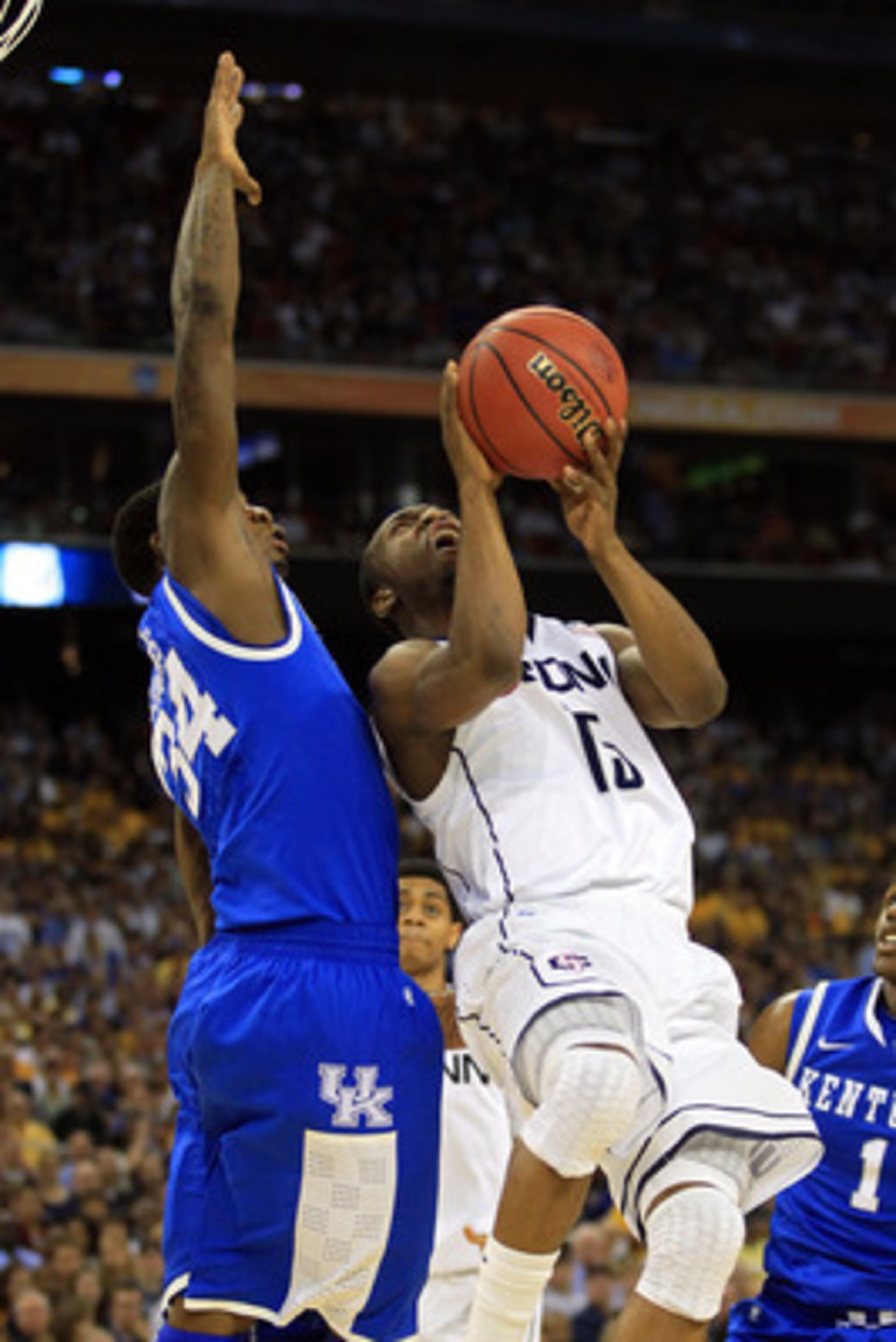 HOUSTON, TX - APRIL 02:  Kemba Walker #15 of the Connecticut Huskies goes up for a shoot against DeAndre Liggins #34 of the Kentucky Wildcats during the National Semifinal game of the 2011 NCAA Division I Men's Basketball Championship at Reliant Stadium o