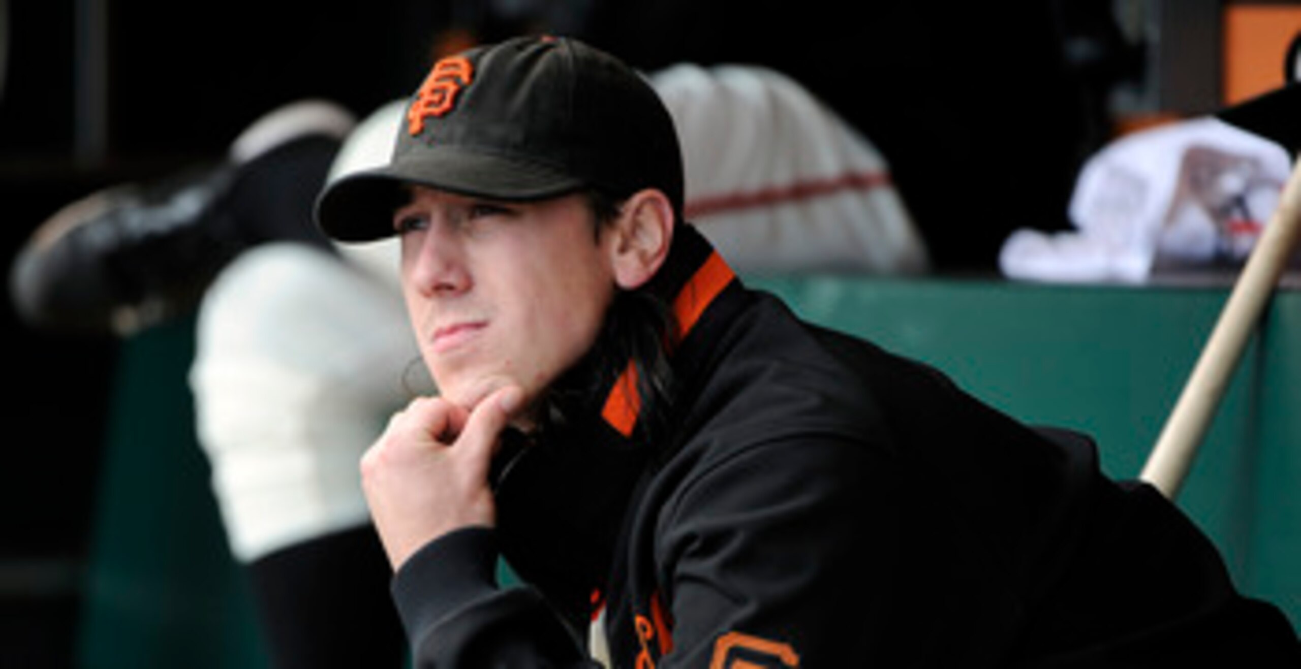 SAN FRANCISCO, CA - JUNE 11: Tim Lincecum #55 of the San Francisco Giants sits in the dugout looking up at the score board after being taken out down 6 to 0 against the Cincinnati Reds in the fifth inning during a MLB baseball game June 11, 2011 at AT&T P