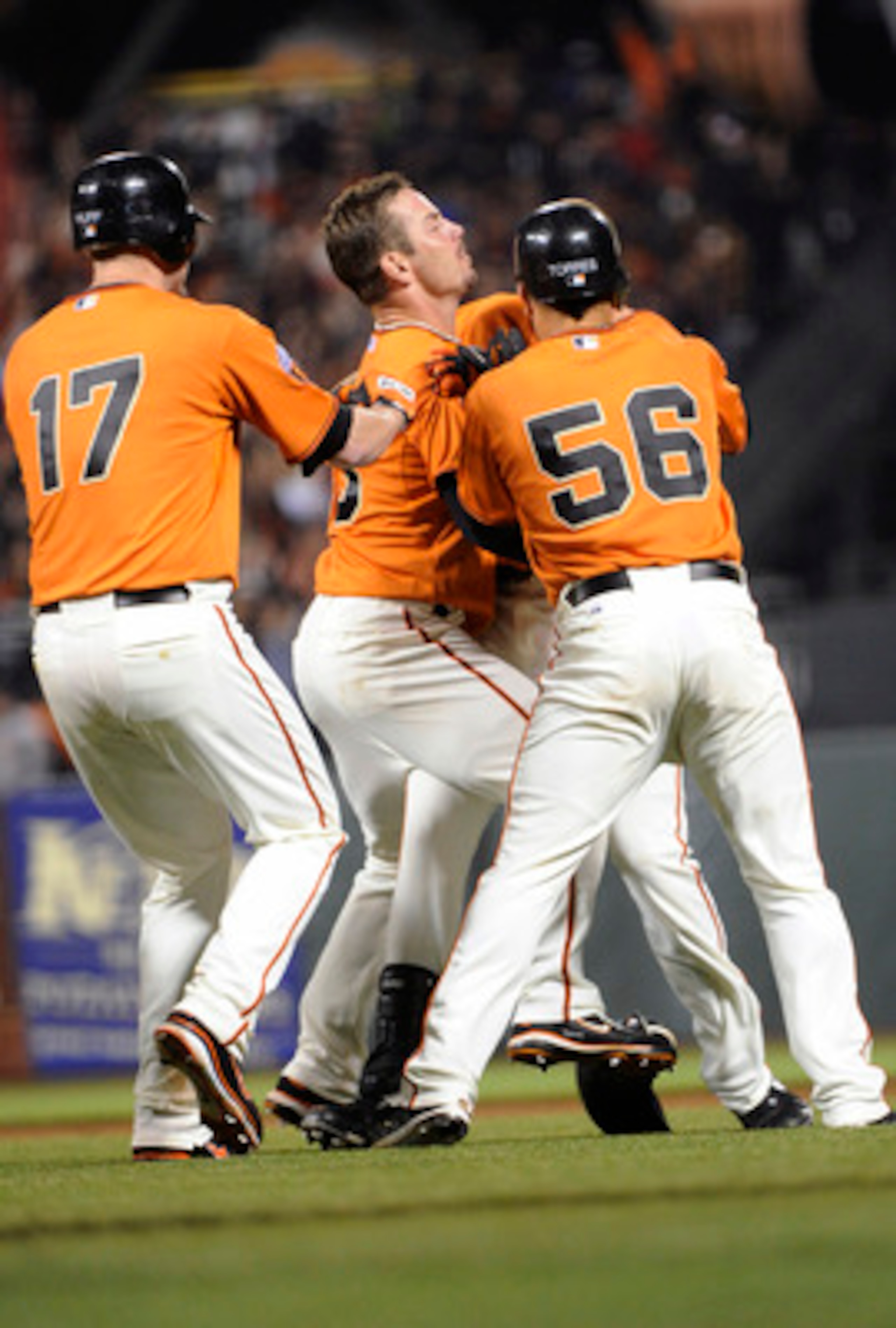SAN FRANCISCO, CA - JUNE 10: Nate Schierholtz #12 of the San Francisco Giants after getting the game winning his is smothered by teammates Andres Torres #56, Aaron Rowand #33 and Aubrey Huff #17 during a MLB baseball game against the Cincinnati Reds June