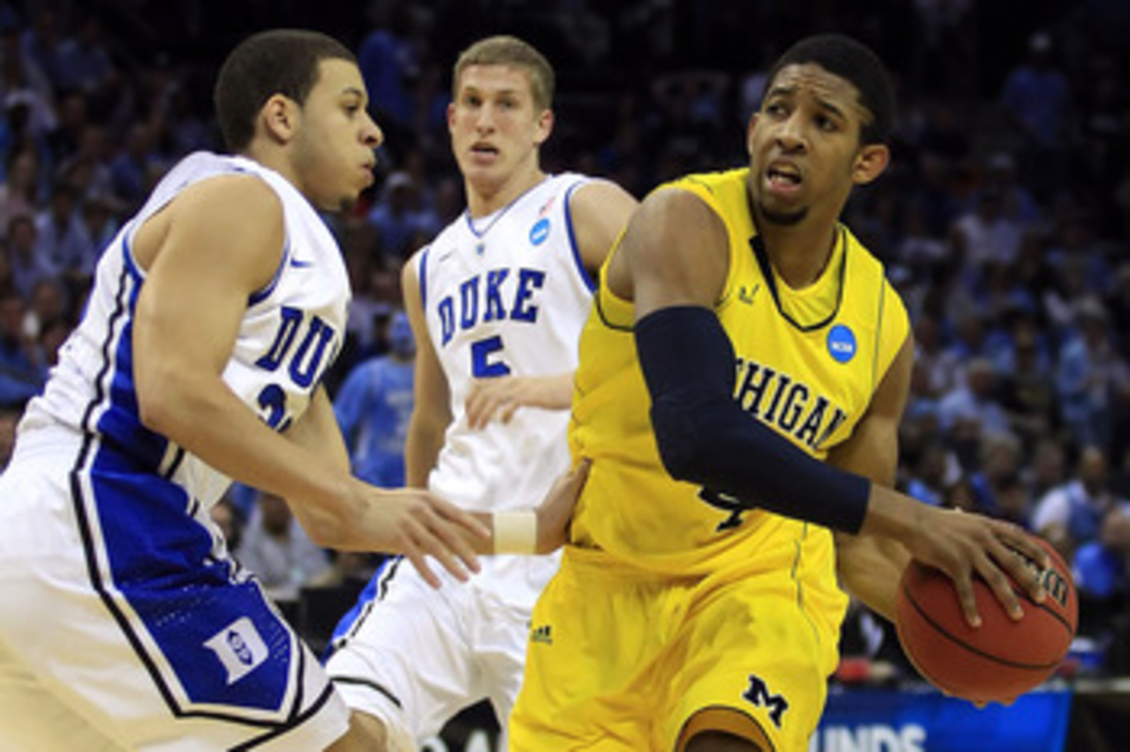 CHARLOTTE, NC - MARCH 20: Darius Morris #4 of the Michigan Wolverines drives on Seth Curry #30 of the Duke Blue Devils in the first half during the third round of the 2011 NCAA men's basketball tournament at Time Warner Cable Arena on March 20, 2011 in Ch