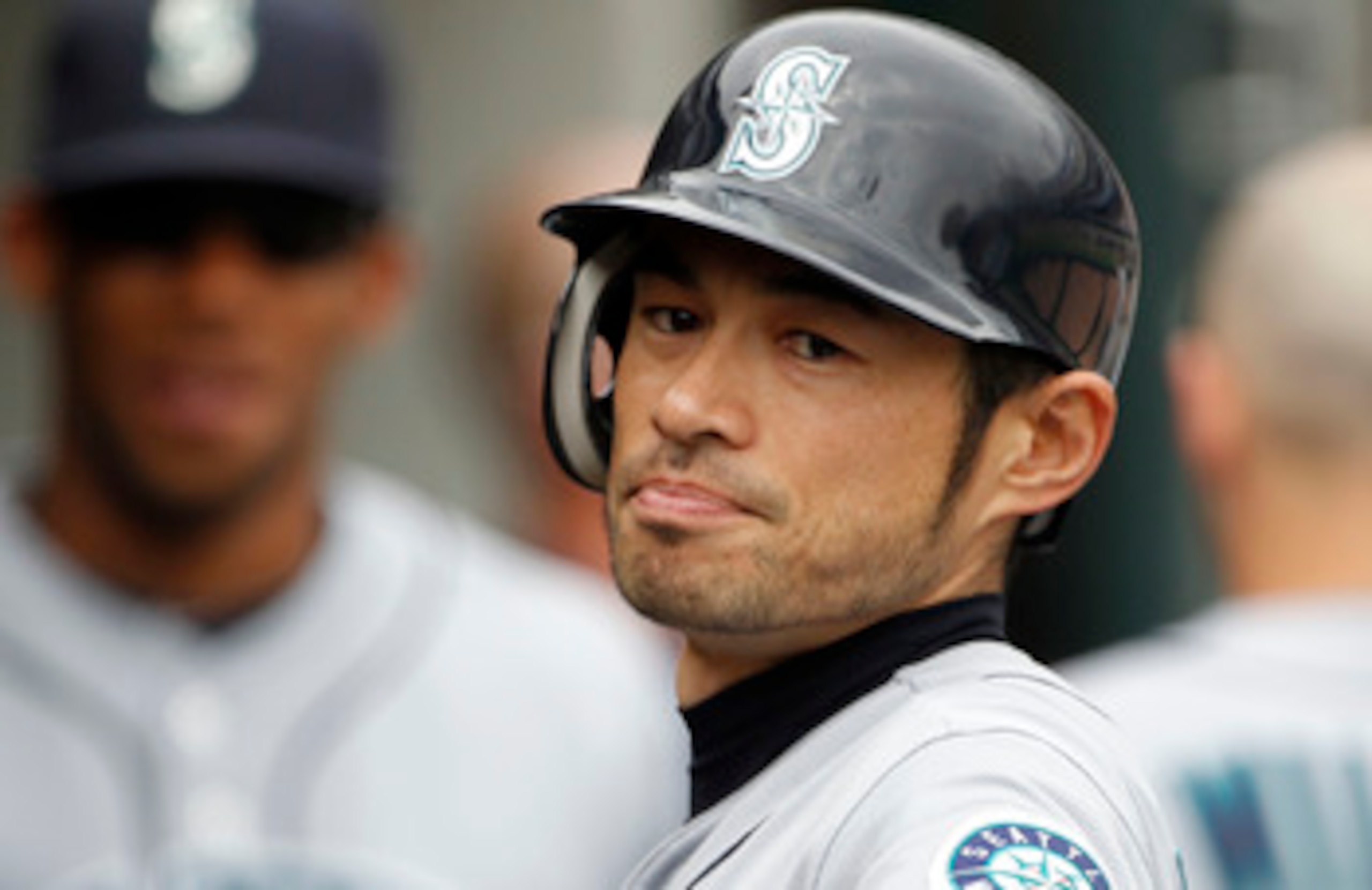 DETROIT - JUNE 12:  Ichiro Suzuki #51 of the Seattle Mariners scores in the fifth inning and is congratulated by his teammates during the game at Comerica Park on June 12, 2011 in Detroit, Michigan. Seattle defeated Detroit 7-3.  (Photo by Leon Halip/Gett