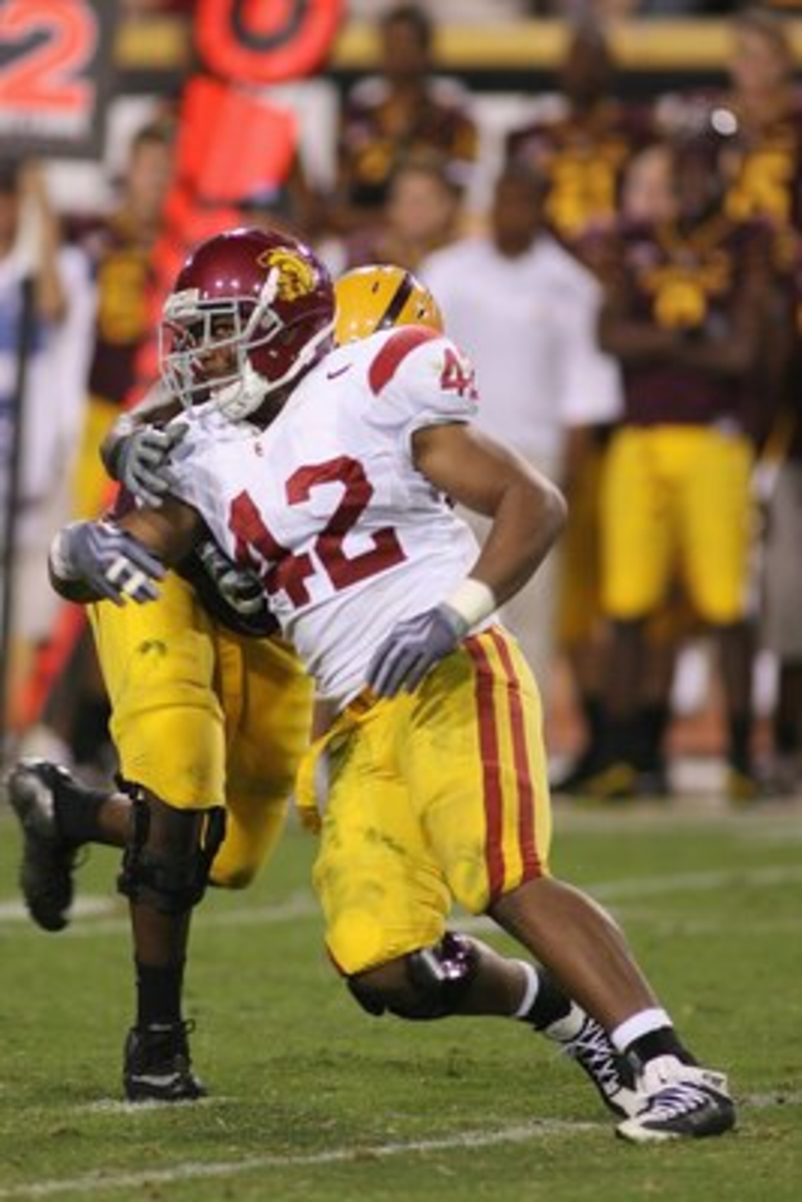 TEMPE, AZ - NOVEMBER 7:  Devon Kennard #42 of the USC Trojans rushes against the Arizona State Sun Devils on November 7, 2009 at Sun Devil Stadium in Tempe, Arizona.  USC won 14-9.  (Photo by Jeff Golden/Getty Images)