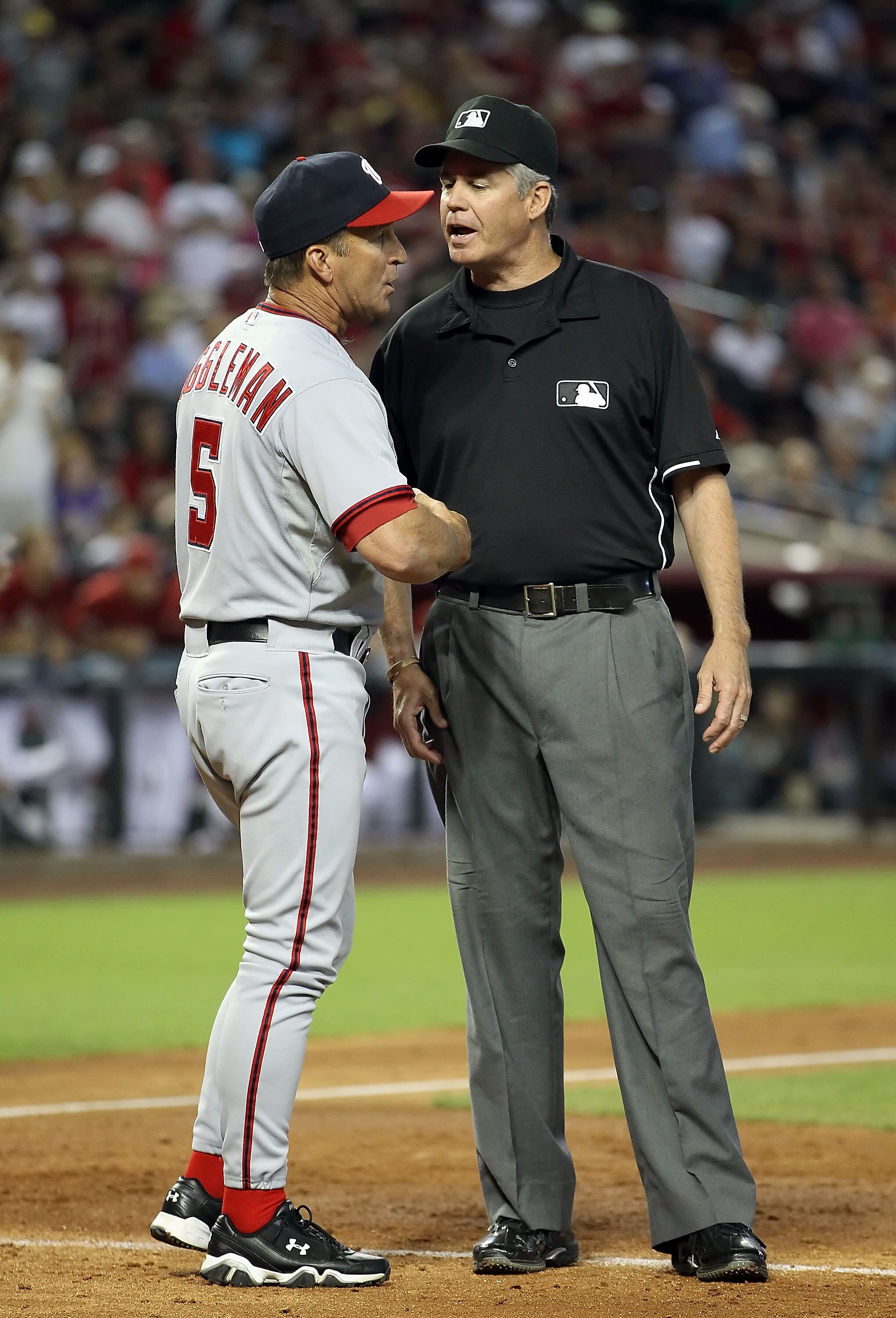 PHOENIX, AZ - JUNE 05:  Manager Jim Riggleman of the Washington Nationals argues with umpire Gary Darling during the Major League Baseball game against the Arizona Diamondbacks at Chase Field on June 5, 2011 in Phoenix, Arizona.  (Photo by Christian Peter