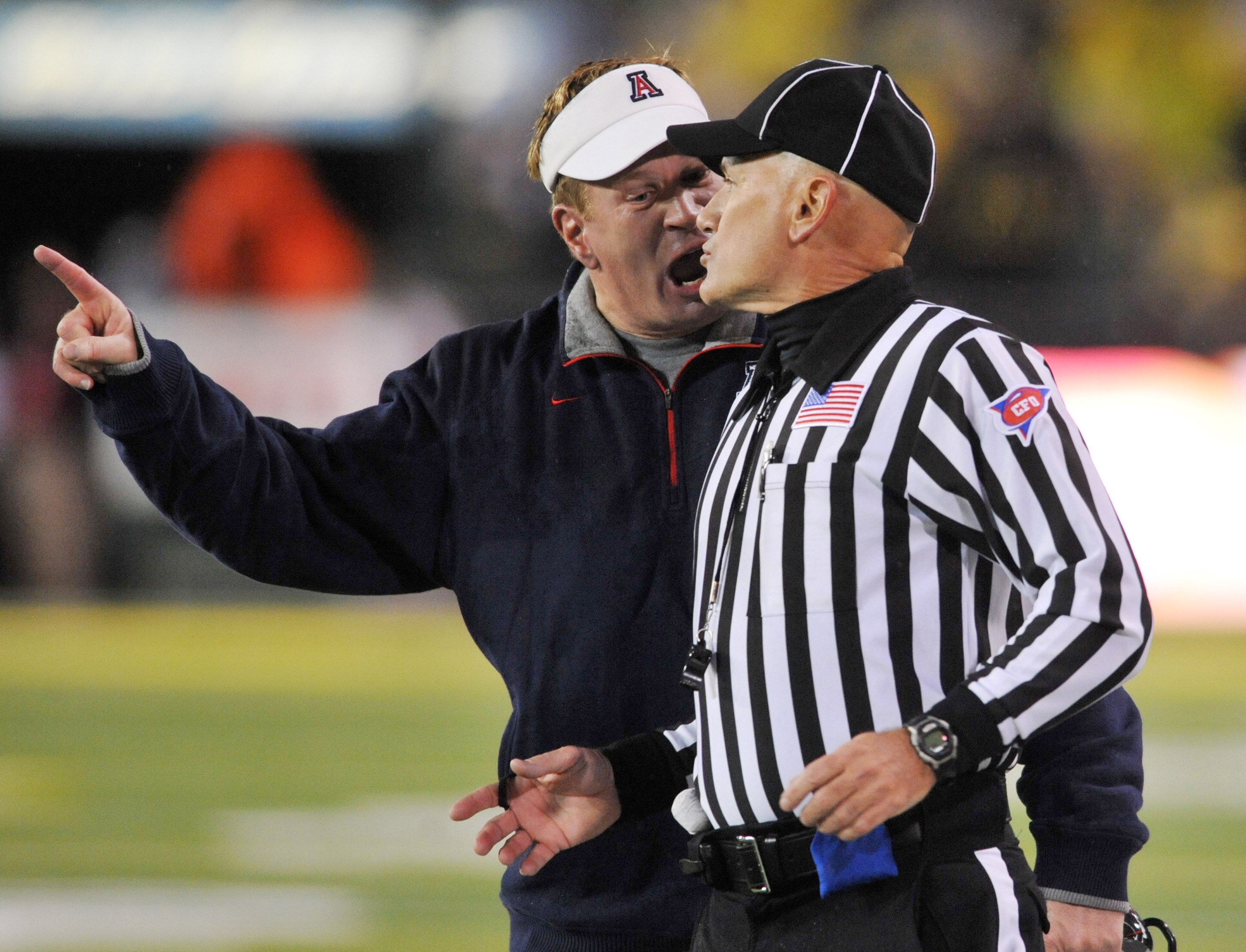EUGENE, OR - NOVEMBER 26: Head coach Mike Stoops of the Arizona Wildcats has some words with an official in the second quarter of the game against the the Oregon Ducks at Autzen Stadium on November 26, 2010 in Eugene, Oregon. (Photo by Steve Dykes/Getty I EUGENE, OR - NOVEMBER 26: Head coach Mike Stoops of the Arizona Wildcats has some words with an official in the second quarter of the game against the the Oregon Ducks at Autzen Stadium on November 26, 2010 in Eugene, Oregon. (Photo by Steve Dykes/Getty I