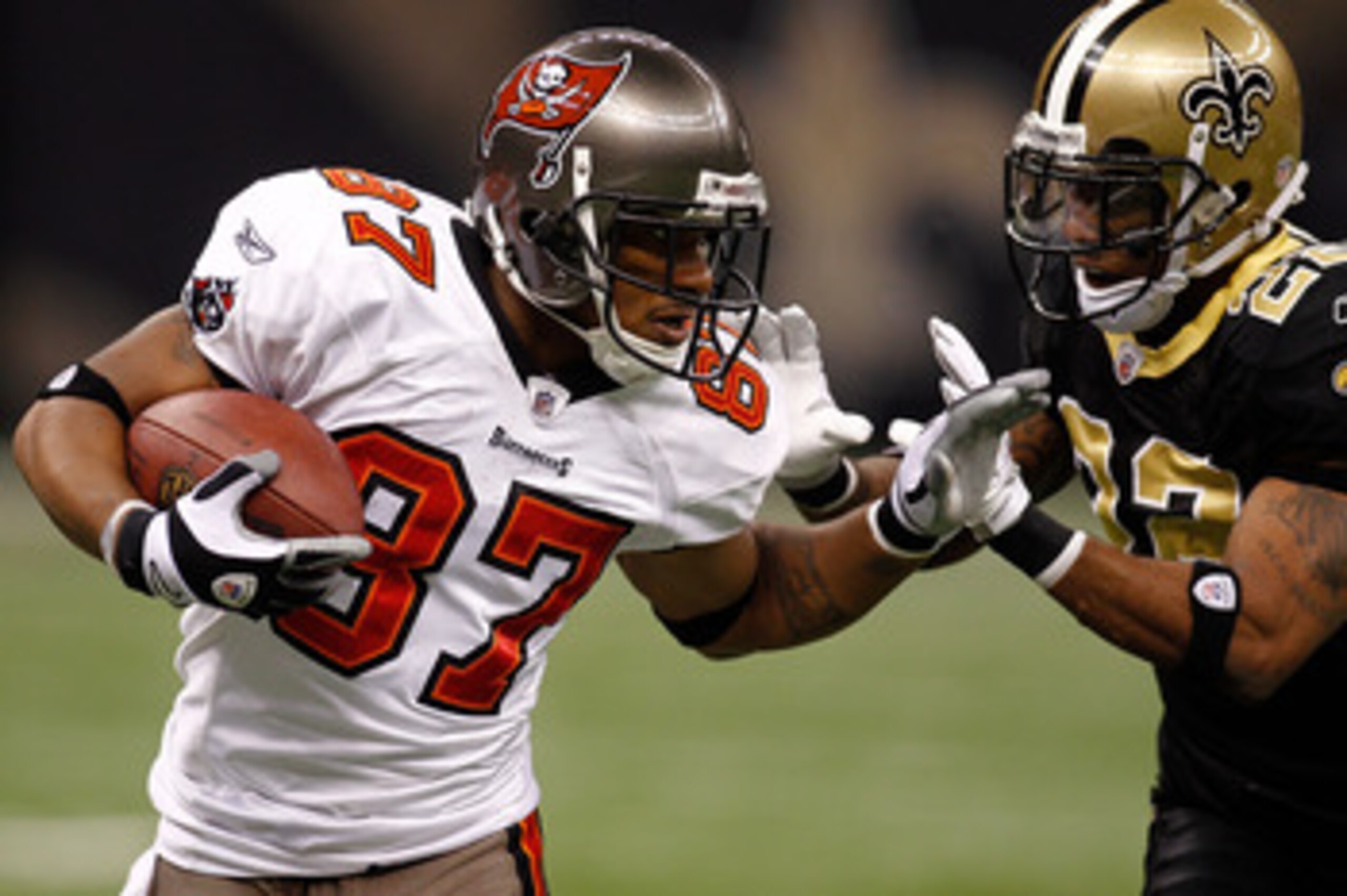 NEW ORLEANS, LA - JANUARY 02:  Preston Parker #87 of the Tampa Bay Buccaneers is pushed out of bounds by Tracy Porter #22 of the New Orleans Saints at the Louisiana Superdome on January 2, 2011 in New Orleans, Louisiana.  (Photo by Chris Graythen/Getty Im