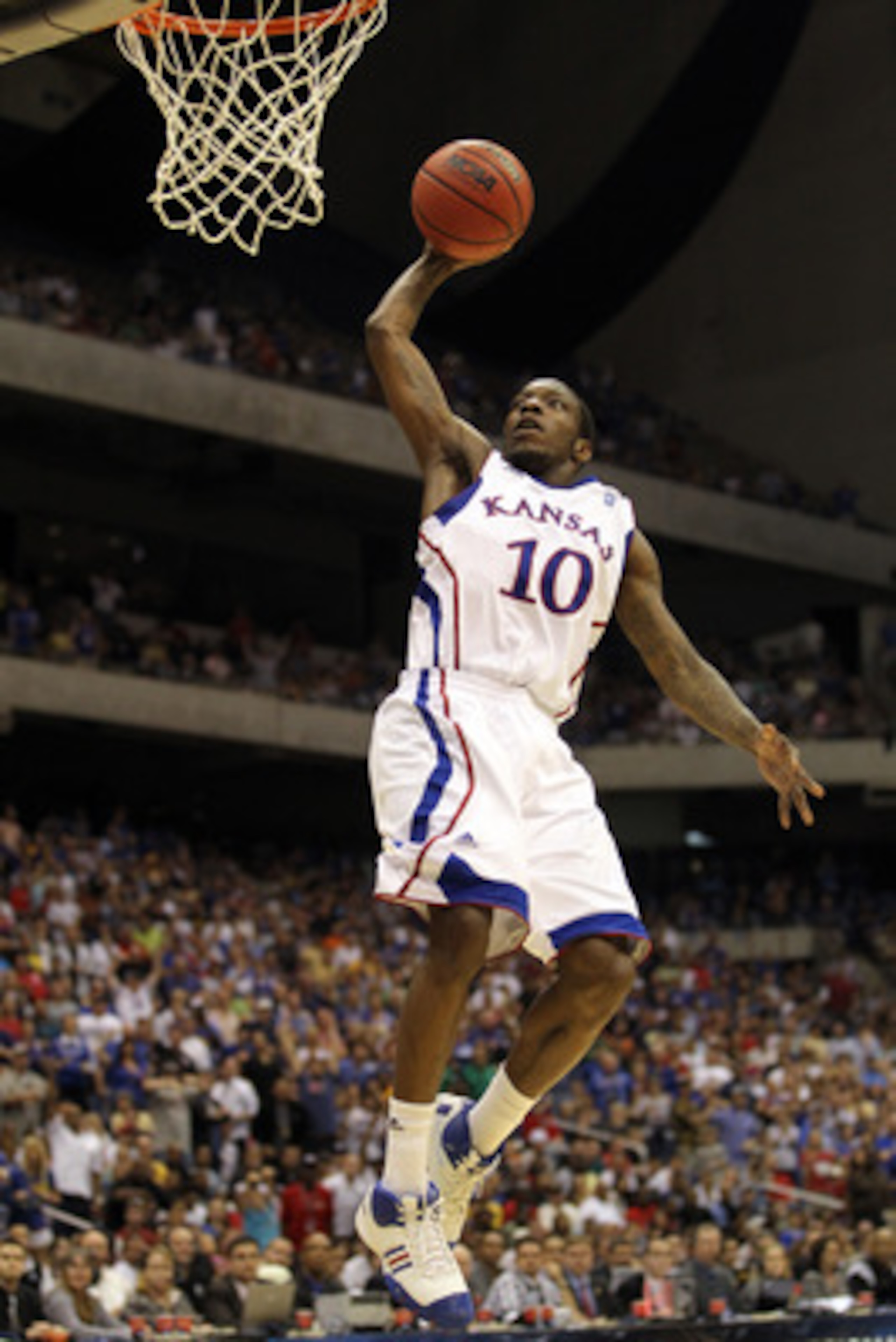 SAN ANTONIO, TX - MARCH 27:  Tyshawn Taylor #10 of the Kansas Jayhawks dunks against the Virginia Commonwealth Rams during the southwest regional final of the 2011 NCAA men's basketball tournament at the Alamodome on March 27, 2011 in San Antonio, Texas.