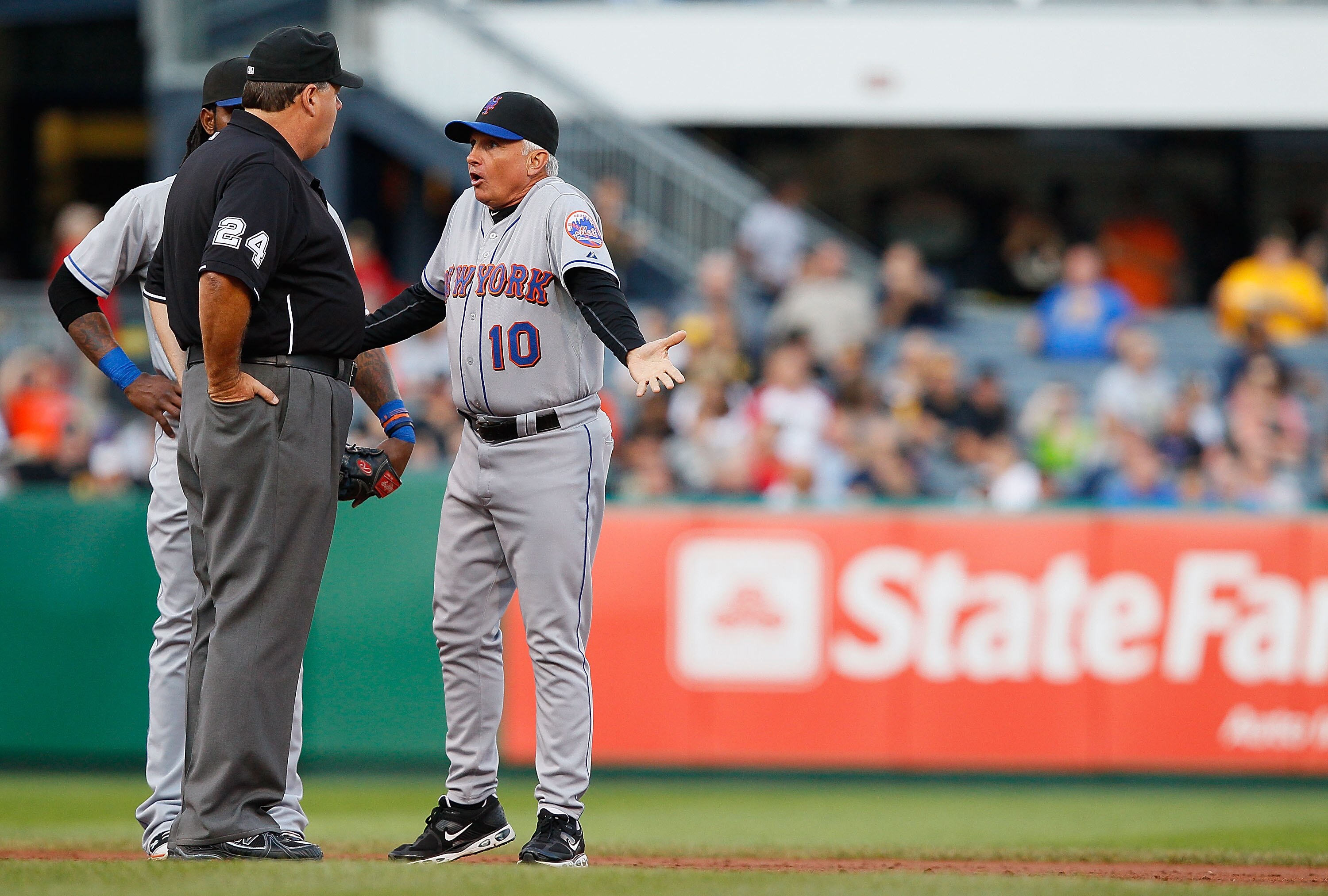 PITTSBURGH - JUNE 13: Manager Terry Collins #10 and Jose Reyes #7 of the New York Mets argues a call with second base umpire Jerry Layne during the game on June 13, 2011 at PNC Park in Pittsburgh, Pennsylvania.  (Photo by Jared Wickerham/Getty Images)