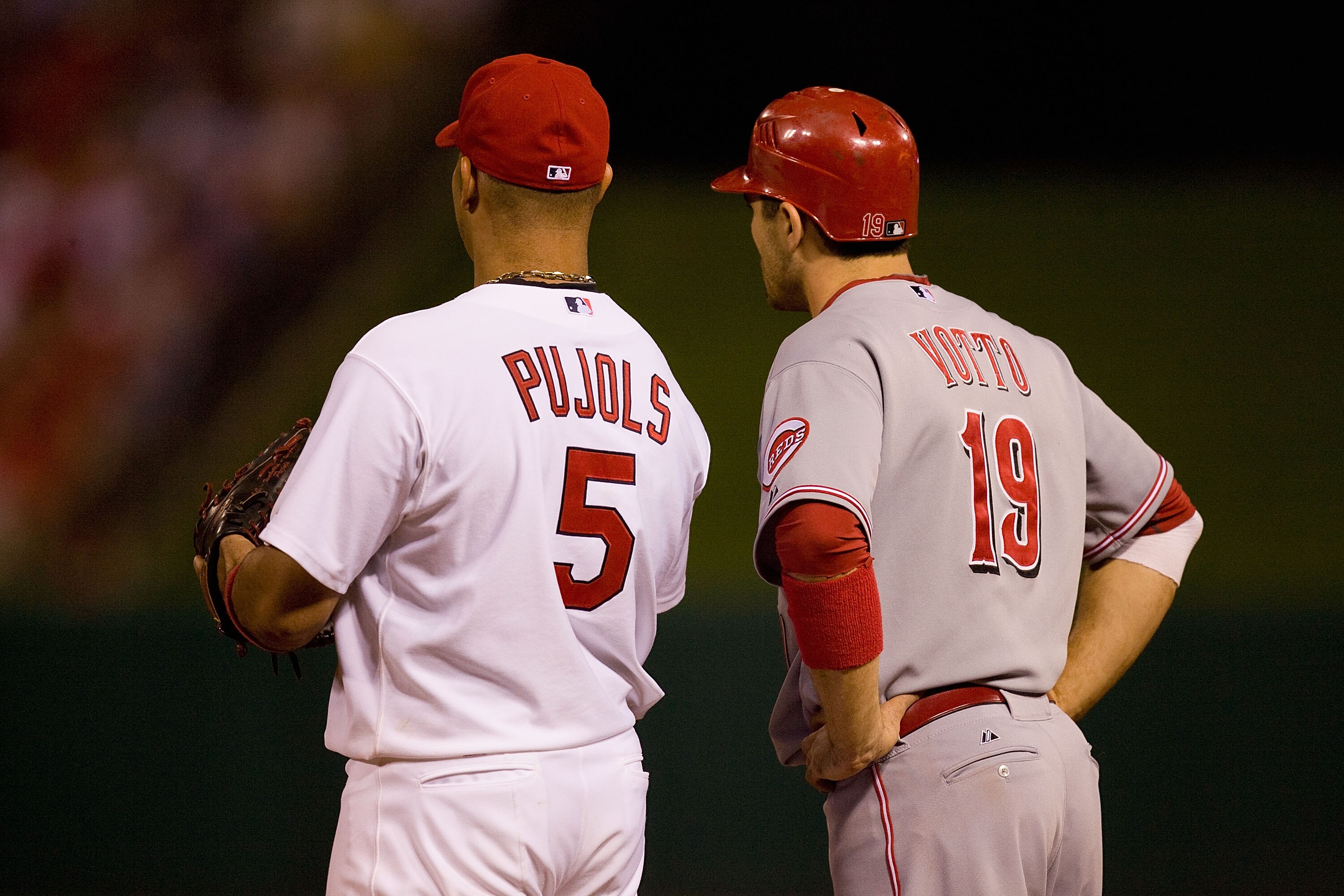 ST. LOUIS - SEPTEMBER 3: Albert Pujols #5 of the St. Louis Cardinals and Joey Votto #19 of the Cincinnati Reds stand on first base at Busch Stadium on September 3, 2010 in St. Louis, Missouri.  The Cardinals beat the Reds 3-2.  (Photo by Dilip Vishwanat/G