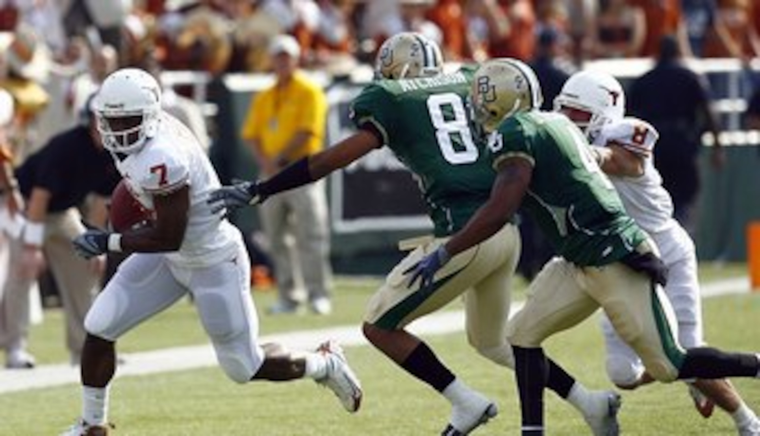 WACO, TX - NOVEMBER 14:  Wide receiver John Chiles #7 of the Texas Longhorns carries the ball during the second half against corner back Tim Atchison #8 and linebacker Jeremy Williams #4 of the Baylor Bears on November 14, 2009 at Floyd Casey Stadium in W