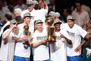MIAMI, FL - JUNE 12:  (L-R) Brian Cardinal #35, Finals MVP Dirk Nowitzki #41, Jason Kidd #2, Jason Terry #31 and Shawn Marion #0 of the Dallas Mavericks celebrate with the Larry O'Brien trophy after they won 105-95 against the Miami Heat in Game Six of th