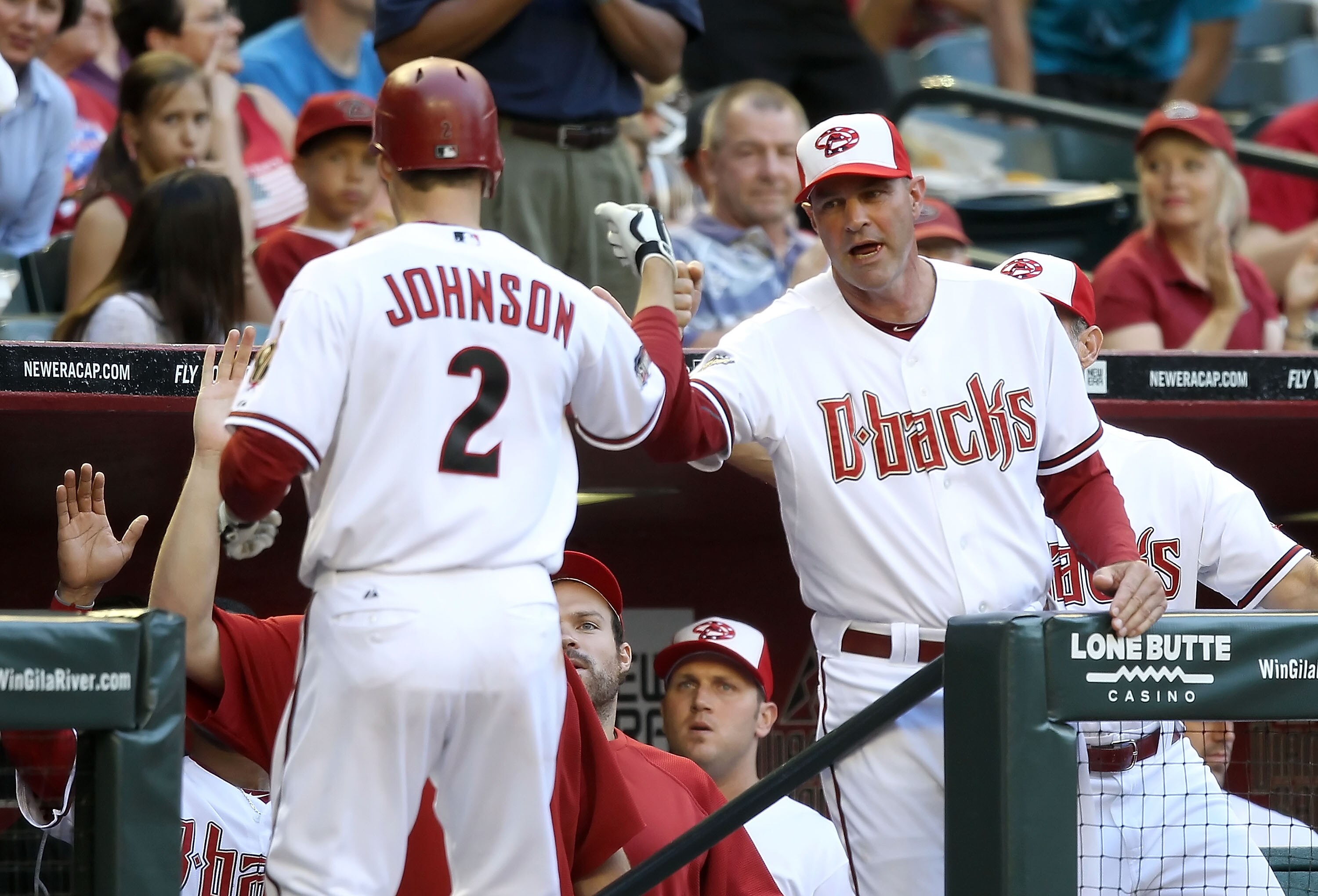 PHOENIX, AZ - MAY 30:  Manager Kirk Gibson of the Arizona Diamondbacks high fives Kelly Johnson #2 after Johnson hit a solo home run against the Florida Marlins during the third inning of the Major League Baseball game at Chase Field on May 30, 2011 in Ph
