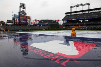 DENVER, CO - MAY 12:  The the tarp covers the infield as the rain falls causing a delay in the start of the game between the New York Mets and the Colorado Rockies at Coors Field on May 12, 2011 in Denver, Colorado.  (Photo by Doug Pensinger/Getty Images)