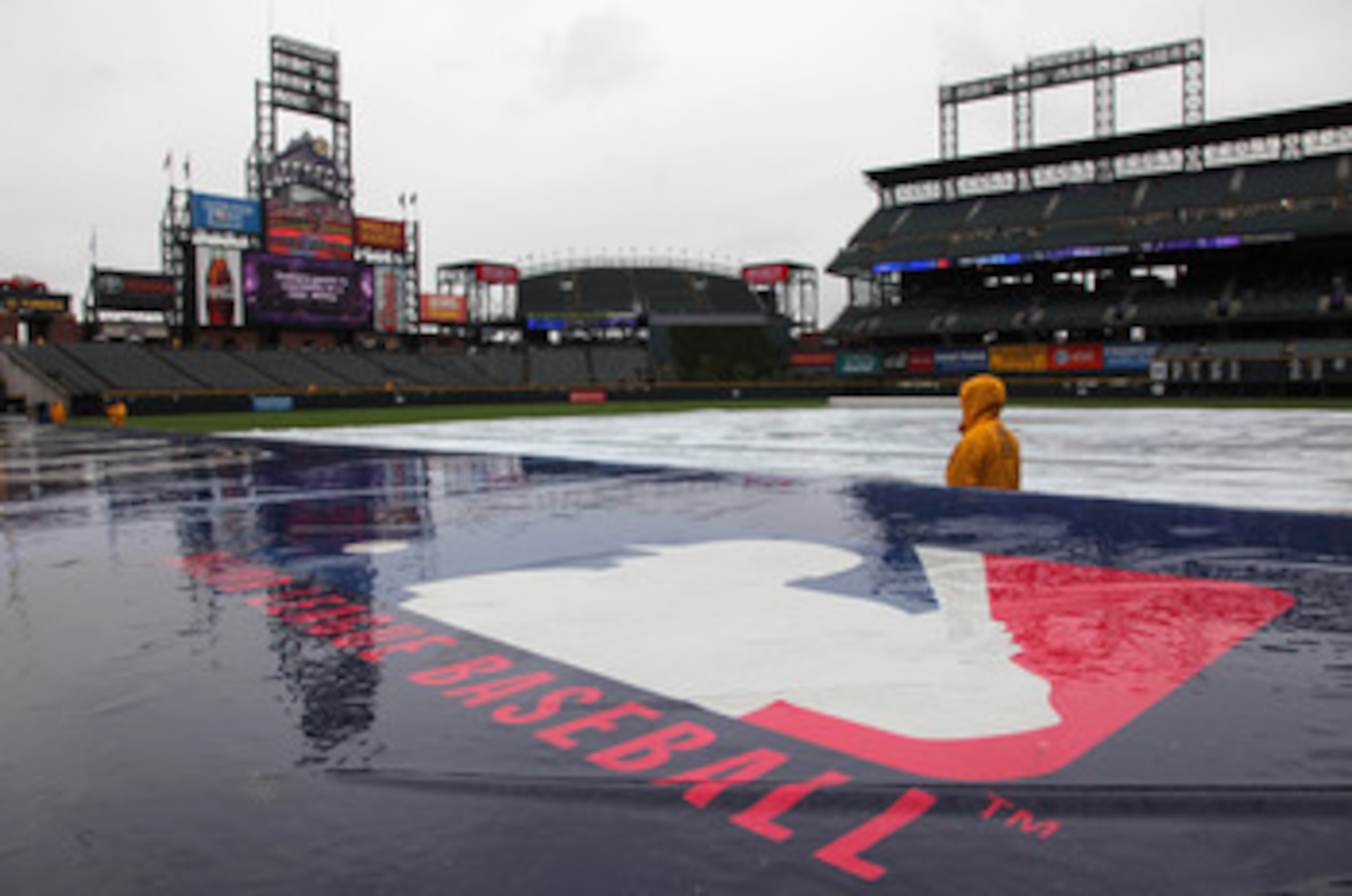 DENVER, CO - MAY 12:  The the tarp covers the infield as the rain falls causing a delay in the start of the game between the New York Mets and the Colorado Rockies at Coors Field on May 12, 2011 in Denver, Colorado.  (Photo by Doug Pensinger/Getty Images)