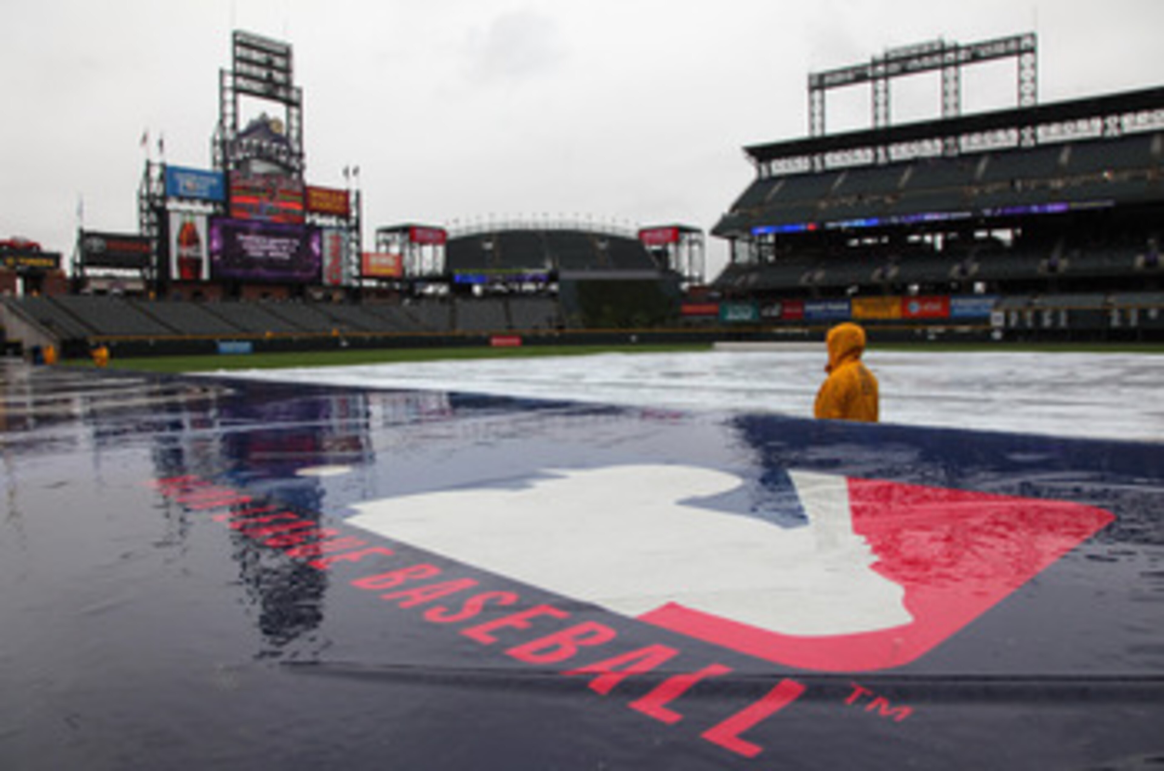 DENVER, CO - MAY 12:  The the tarp covers the infield as the rain falls causing a delay in the start of the game between the New York Mets and the Colorado Rockies at Coors Field on May 12, 2011 in Denver, Colorado.  (Photo by Doug Pensinger/Getty Images)