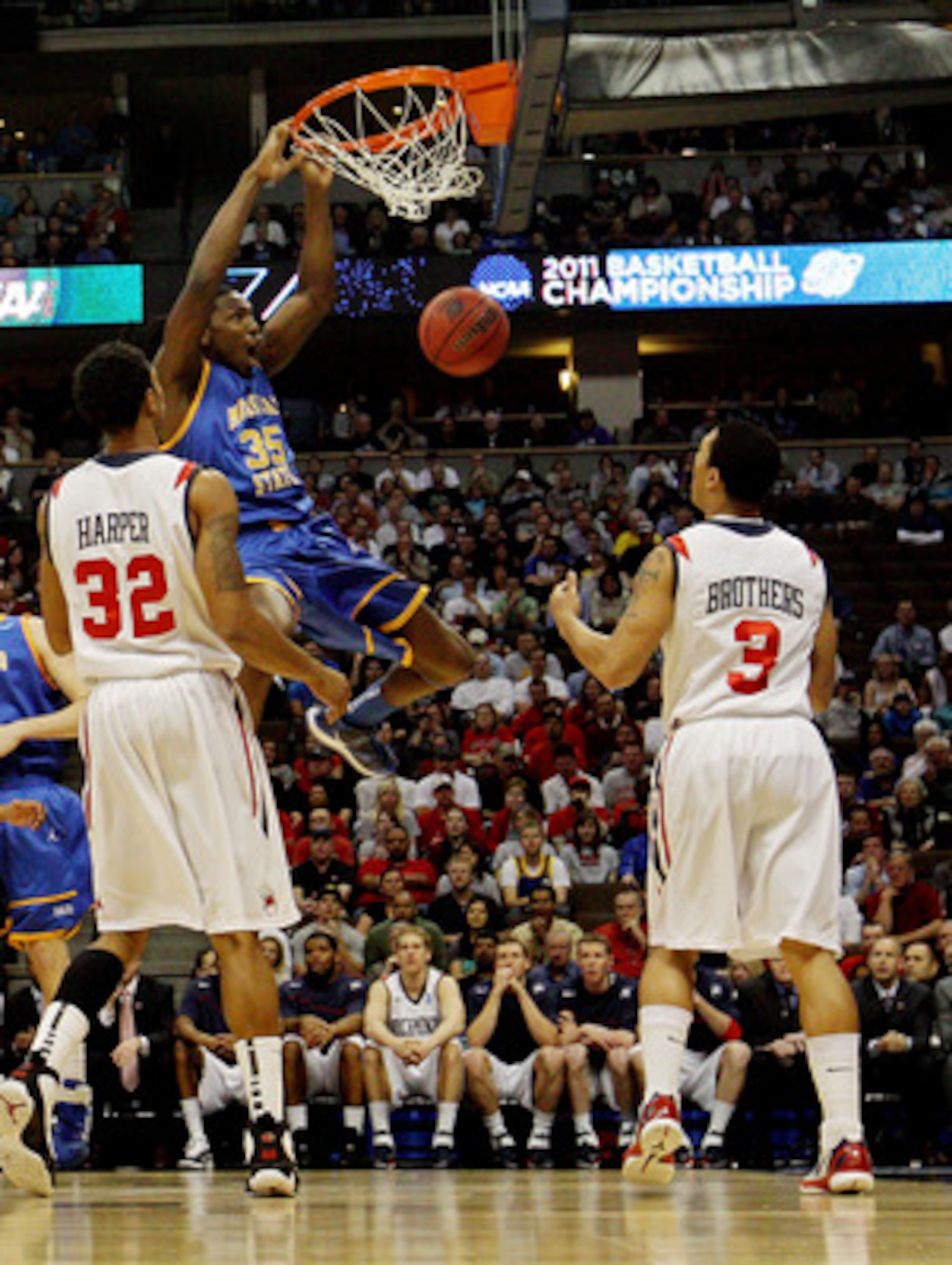DENVER, CO - MARCH 19:  Kenneth Faried #35 of the Morehead State Eagles dunks the ball against Justin Harper #32 and Darien Brothers #3 of the Richmond Spiders during the third round of the 2011 NCAA men's basketball tournament at Pepsi Center on March 19