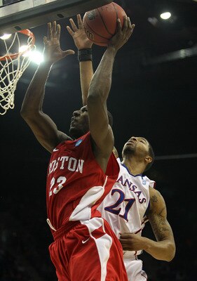TULSA, OK - MARCH 18:  John Holland #23 of the Boston University Terriers goes up for a shot against Markieff Morris #21 of the Kansas Jayhawks during the second round of the 2011 NCAA men's basketball tournament at BOK Center on March 18, 2011 in Tulsa,