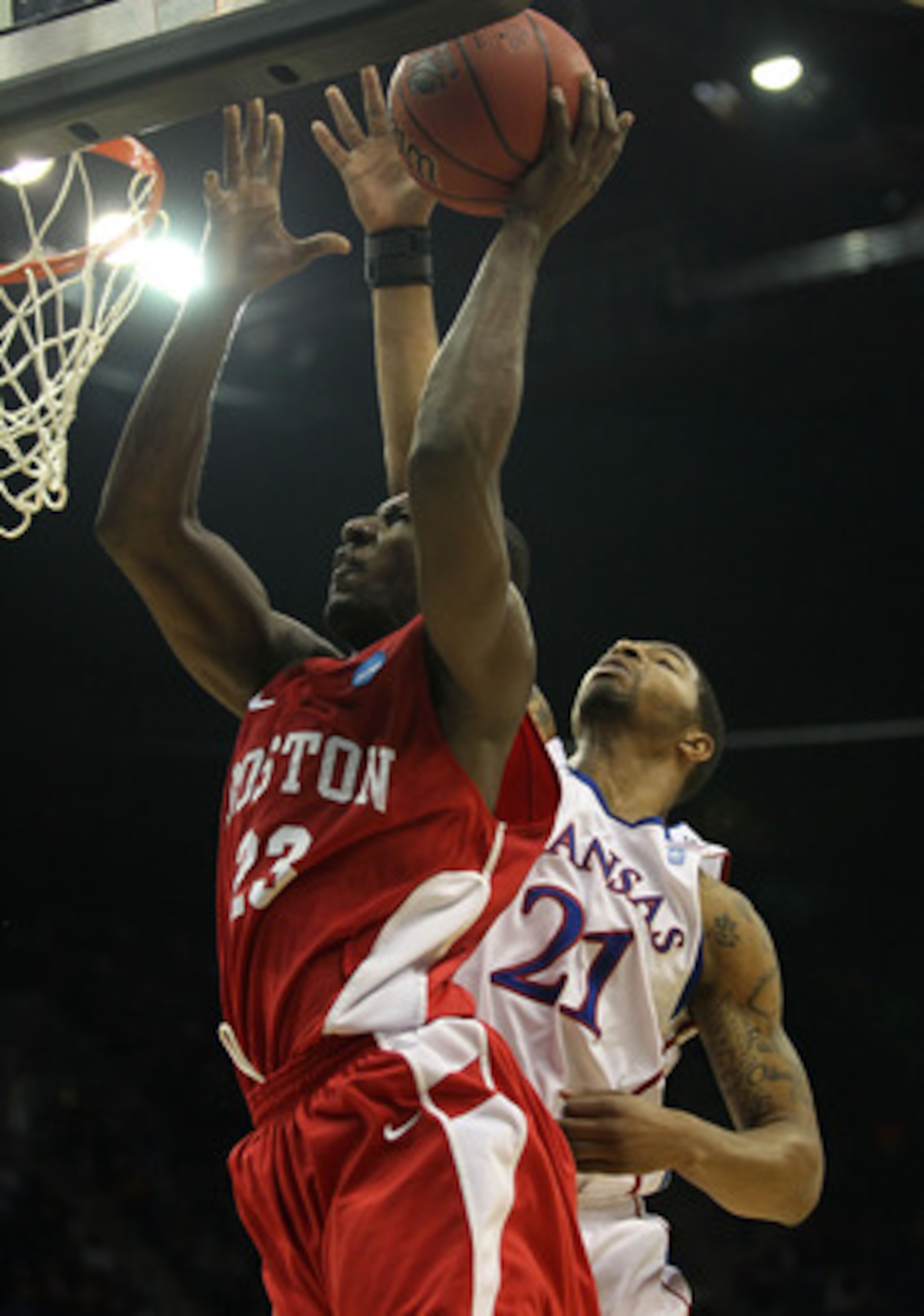 TULSA, OK - MARCH 18:  John Holland #23 of the Boston University Terriers goes up for a shot against Markieff Morris #21 of the Kansas Jayhawks during the second round of the 2011 NCAA men's basketball tournament at BOK Center on March 18, 2011 in Tulsa,