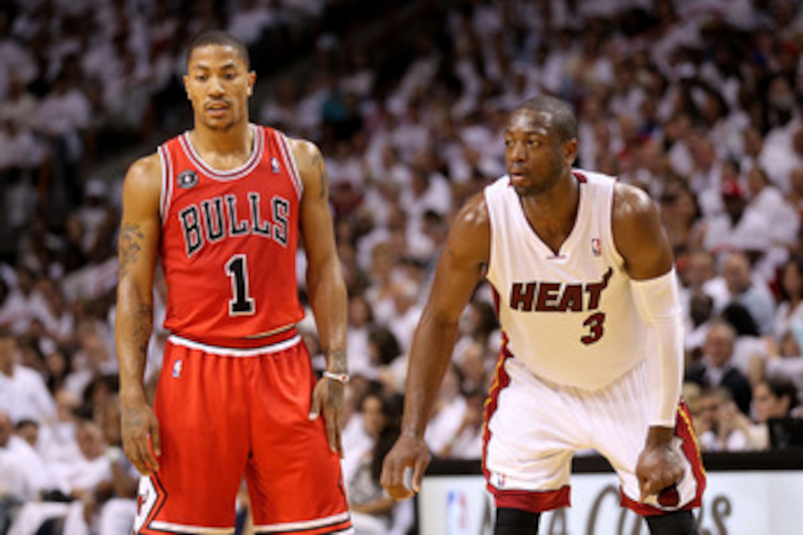 MIAMI, FL - MAY 22:  Derrick Rose #1 of the Chicago Bulls and Dwyane Wade #3 of the Miami Heat look on in Game Three of the Eastern Conference Finals during the 2011 NBA Playoffs on May 22, 2011 at American Airlines Arena in Miami, Florida.  NOTE TO USER: