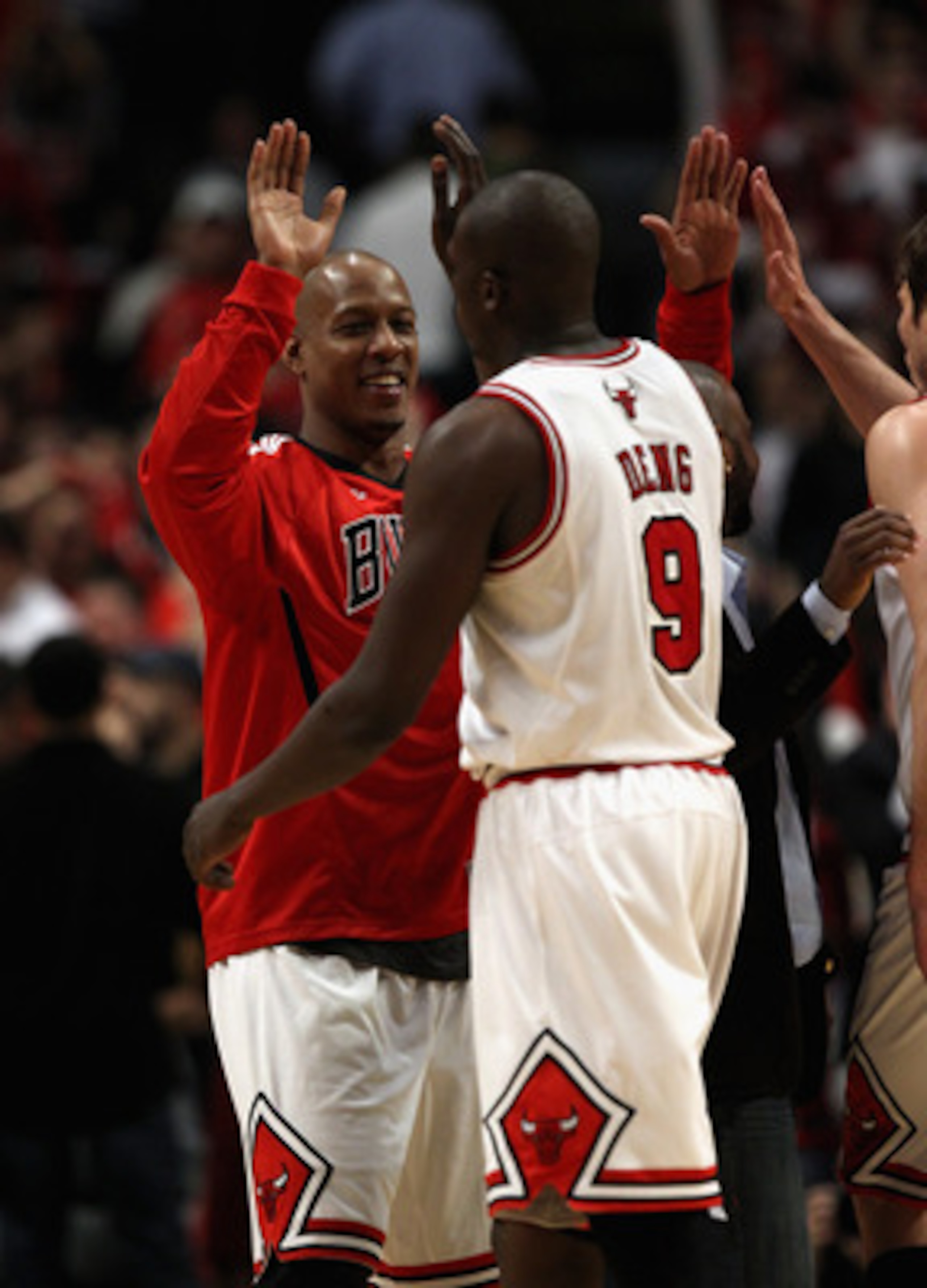 CHICAGO, IL - APRIL 26: Keith Bogans #6 of the Chicago Bulls congratulates teammate Loul Deng #9 during a brake against the Indiana Pacers in Game Five of the Eastern Conference Quarterfinals in the 2011 NBA Playoffs at the United Center on April 26, 2011