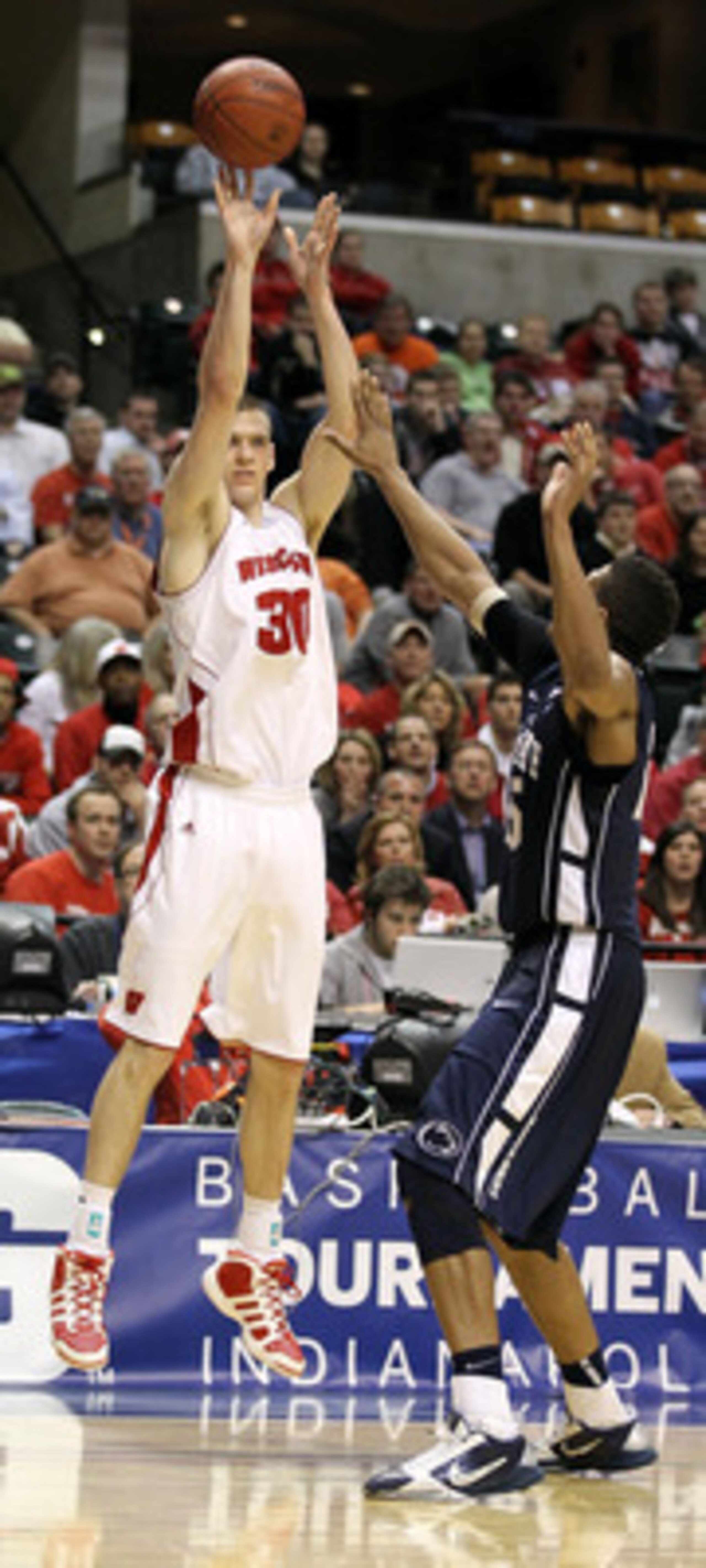 INDIANAPOLIS, IN - MARCH 11:  Jon Leuer #30 of the Wisconsin Badgers attempts a shot against the Penn State Nittany Lions during the quarterfinals of the 2011 Big Ten Men's Basketball Tournament at Conseco Fieldhouse on March 11, 2011 in Indianapolis, Ind