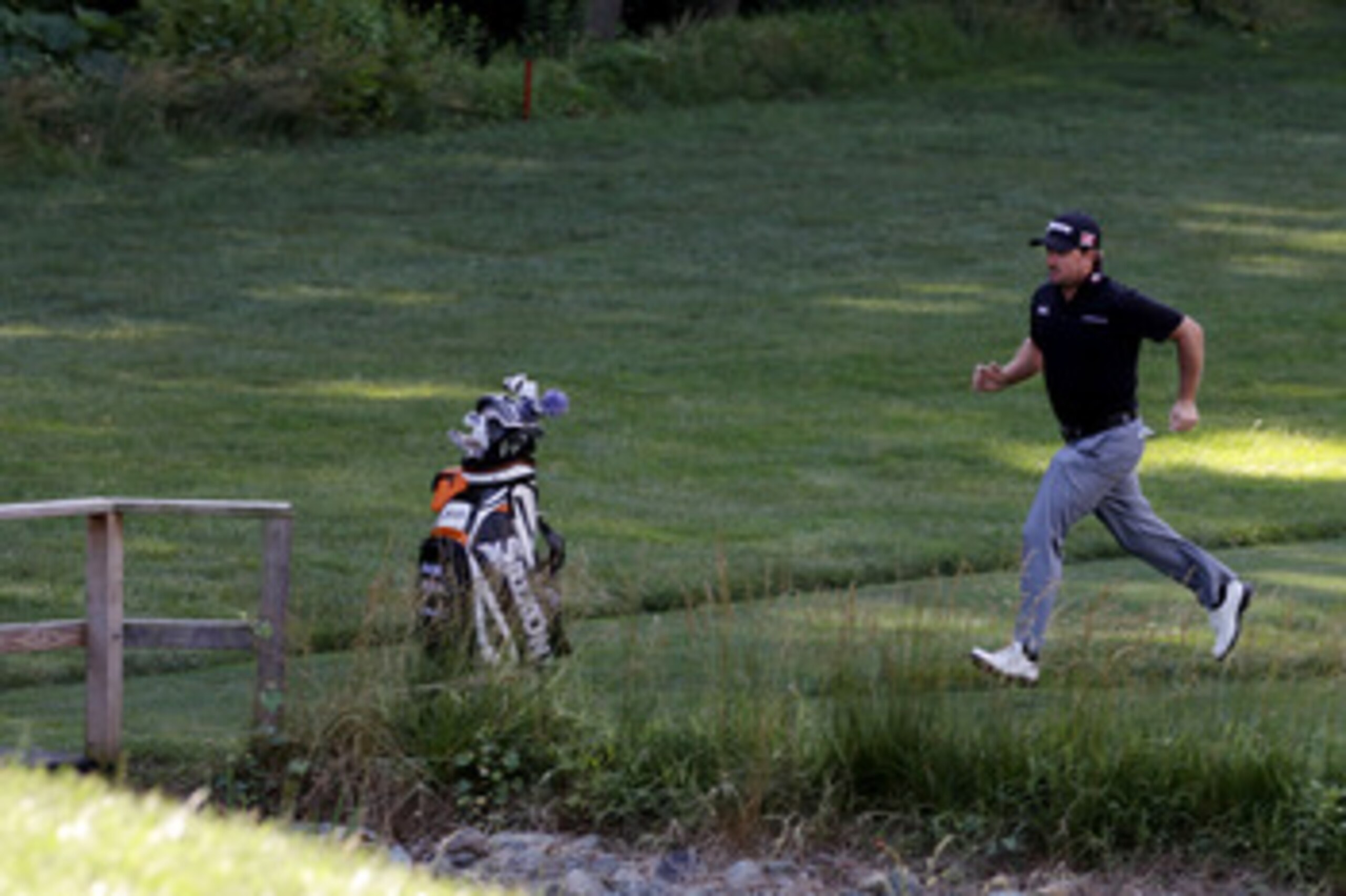 BETHESDA, MD - JUNE 13:  Graeme McDowell of Northern Ireland runs to a tee box during a practice round prior to the start of the 111th U.S. Open at Congressional Country Club on June 13, 2011 in Bethesda, Maryland.  (Photo by Ross Kinnaird/Getty Images)