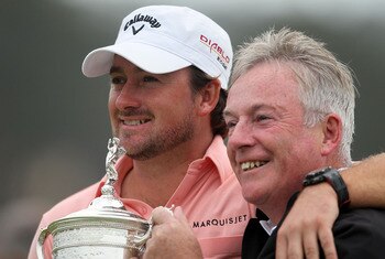 PEBBLE BEACH, CA - JUNE 20:  Graeme McDowell (L) of Northern Ireland celebrates with the trophy alongside his father Ken on the 18th green after winning the 110th U.S. Open at Pebble Beach Golf Links on June 20, 2010 in Pebble Beach, California.  (Photo b