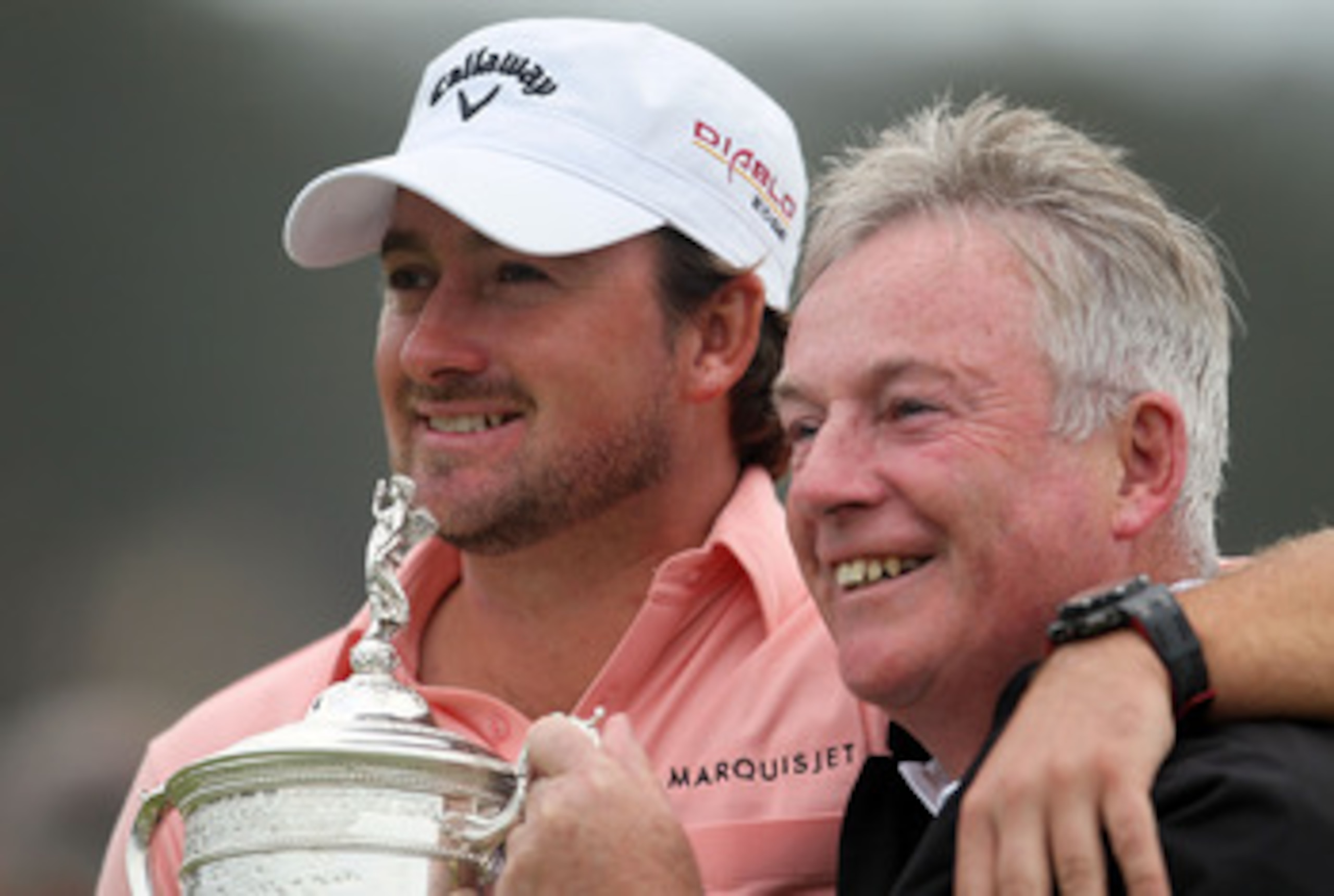 PEBBLE BEACH, CA - JUNE 20:  Graeme McDowell (L) of Northern Ireland celebrates with the trophy alongside his father Ken on the 18th green after winning the 110th U.S. Open at Pebble Beach Golf Links on June 20, 2010 in Pebble Beach, California.  (Photo b