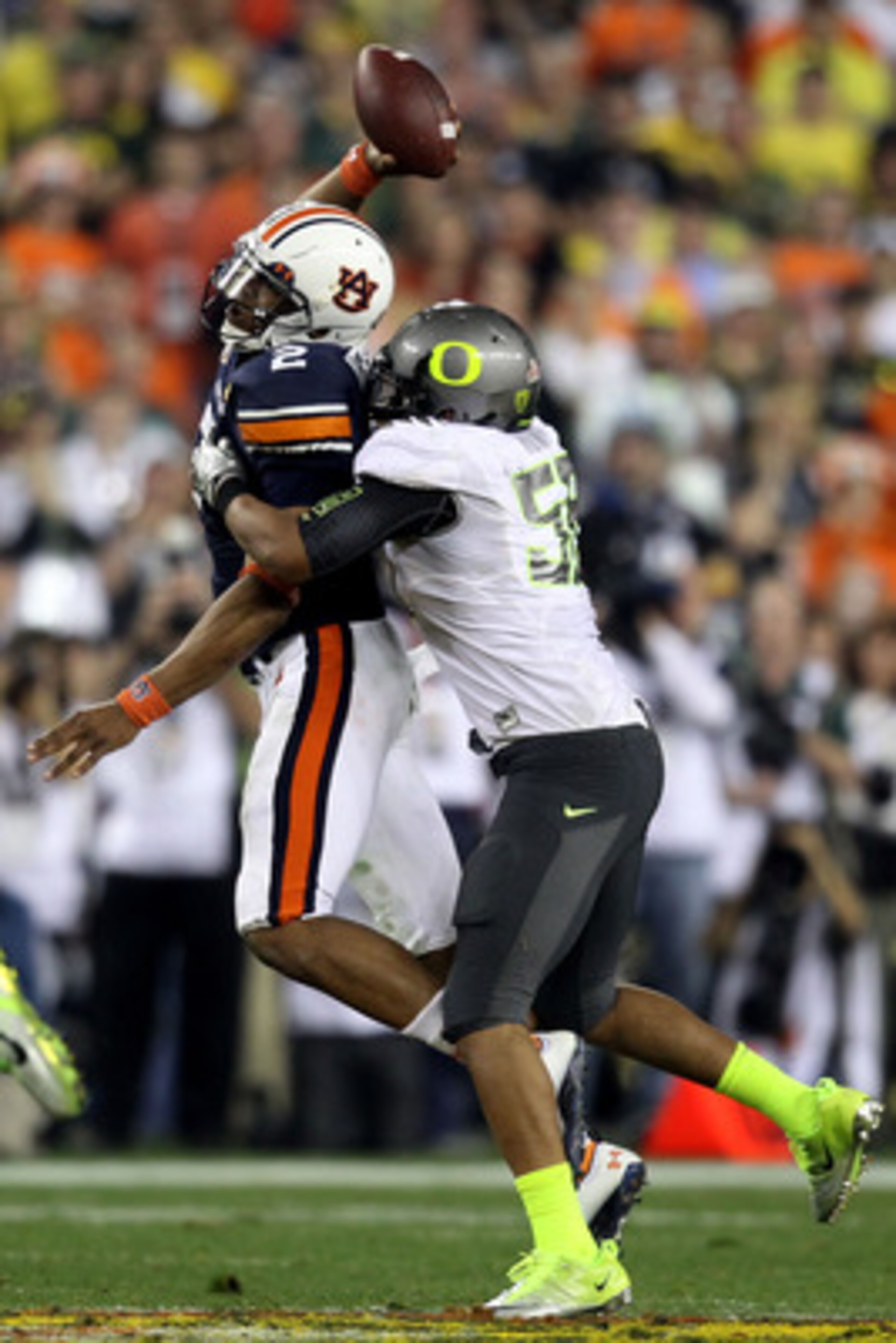 GLENDALE, AZ - JANUARY 10:  Cameron Newton #2 of the Auburn Tigers tries to pass as Kenny Rowe #58 of the Oregon Ducks tries to tackle him during the Tostitos BCS National Championship Game at University of Phoenix Stadium on January 10, 2011 in Glendale,
