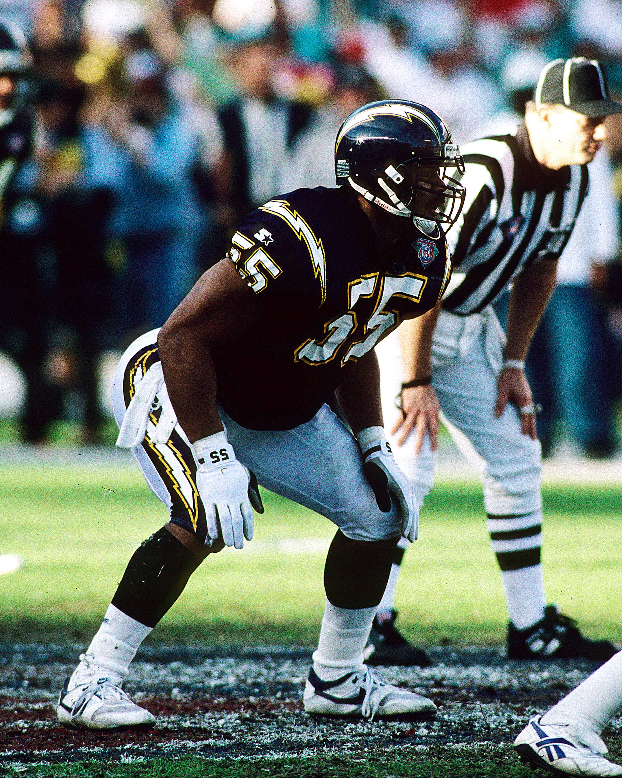 SAN DIEGO, CA - JANUARY 8:  Linebacker Junior Seau of the San Diego Chargers looks into the opposing backfield against the Miami Dolphins in the 1994 AFC Divisional Playoff Game at Jack Murphy Stadium on January 8, 1994 in San Diego, California. The Charg