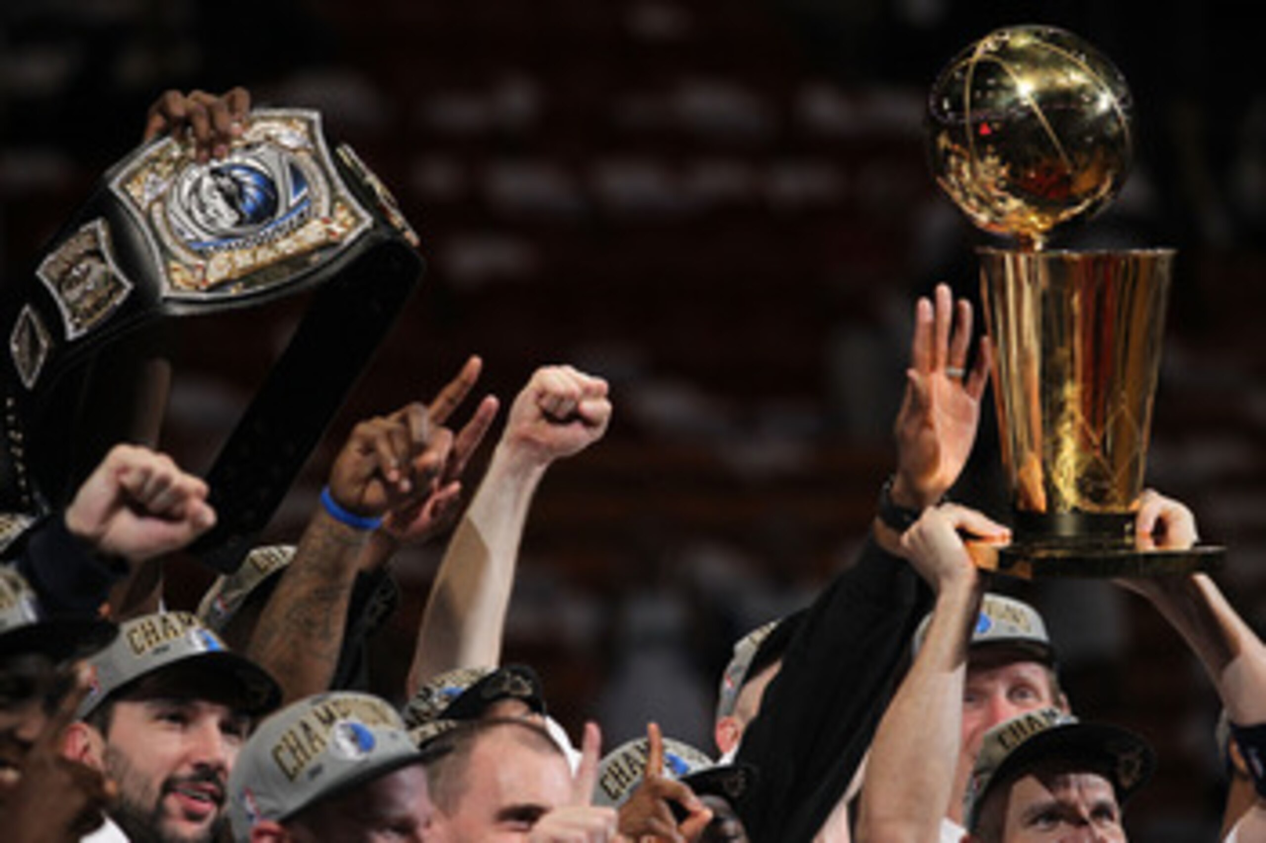 MIAMI, FL - JUNE 12: The Dallas Mavericks celebrate with a belt and the Larry O'Brien trophy after the Mavericks won 105-95 against the Miami Heat in Game Six of the 2011 NBA Finals at American Airlines Arena on June 12, 2011 in Miami, Florida. NOTE TO US