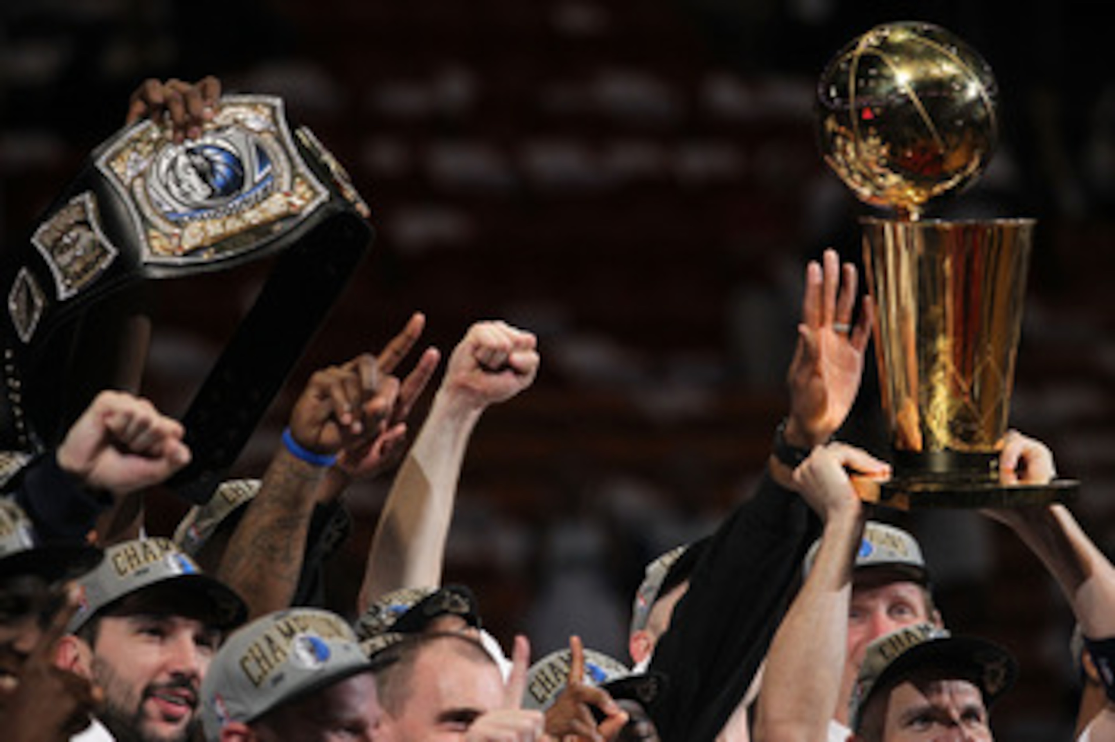 MIAMI, FL - JUNE 12: The Dallas Mavericks celebrate with a belt and the Larry O'Brien trophy after the Mavericks won 105-95 against the Miami Heat in Game Six of the 2011 NBA Finals at American Airlines Arena on June 12, 2011 in Miami, Florida. NOTE TO US