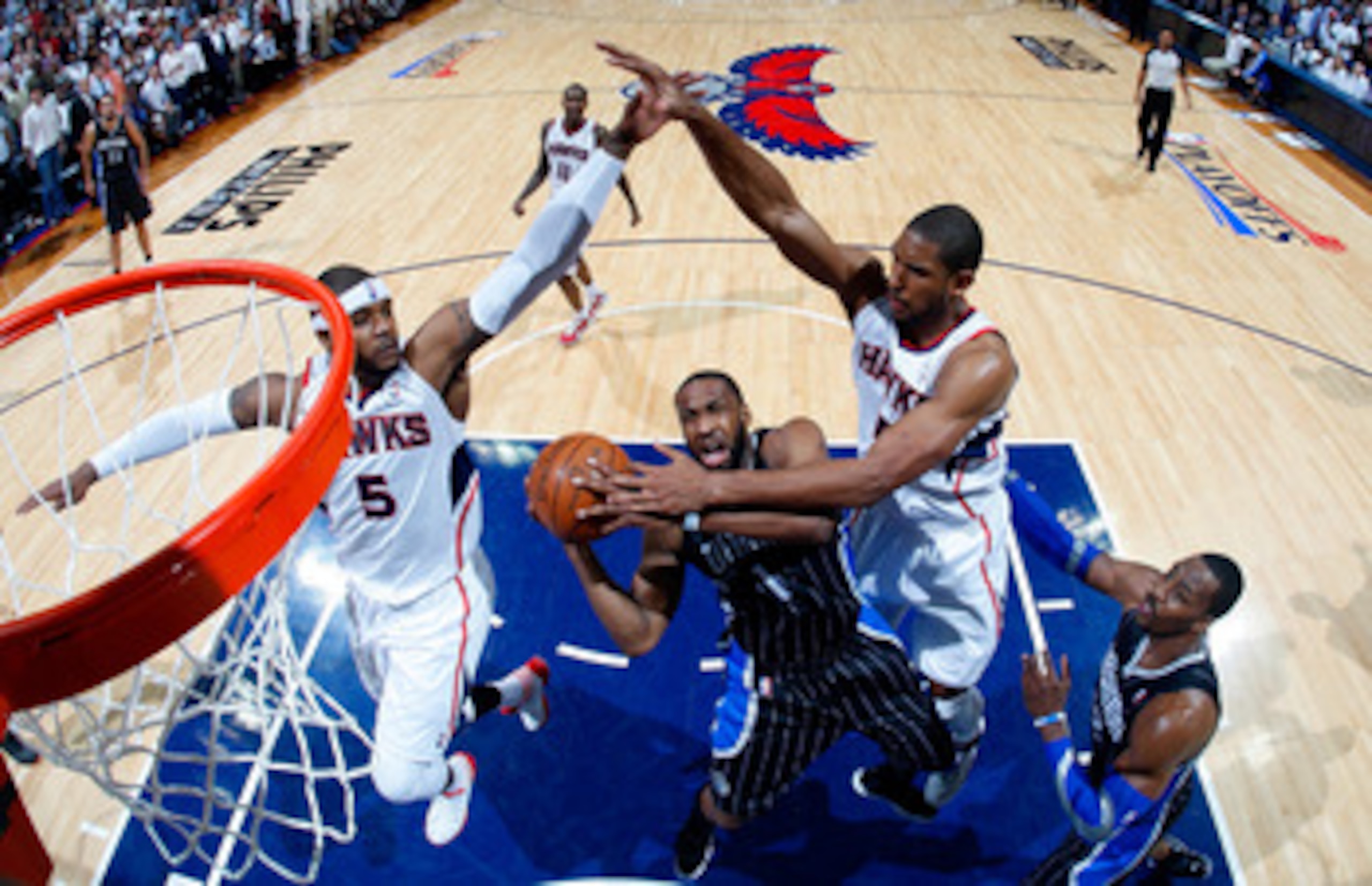 ATLANTA, GA - APRIL 28:  Gilbert Arenas #1 of the Orlando Magic drives to the basket against Josh Smith #5 and Al Horford #15 of the Atlanta Hawks during Game Six of the Eastern Conference Quarterfinals in the 2011 NBA Playoffs at Philips Arena on April 2