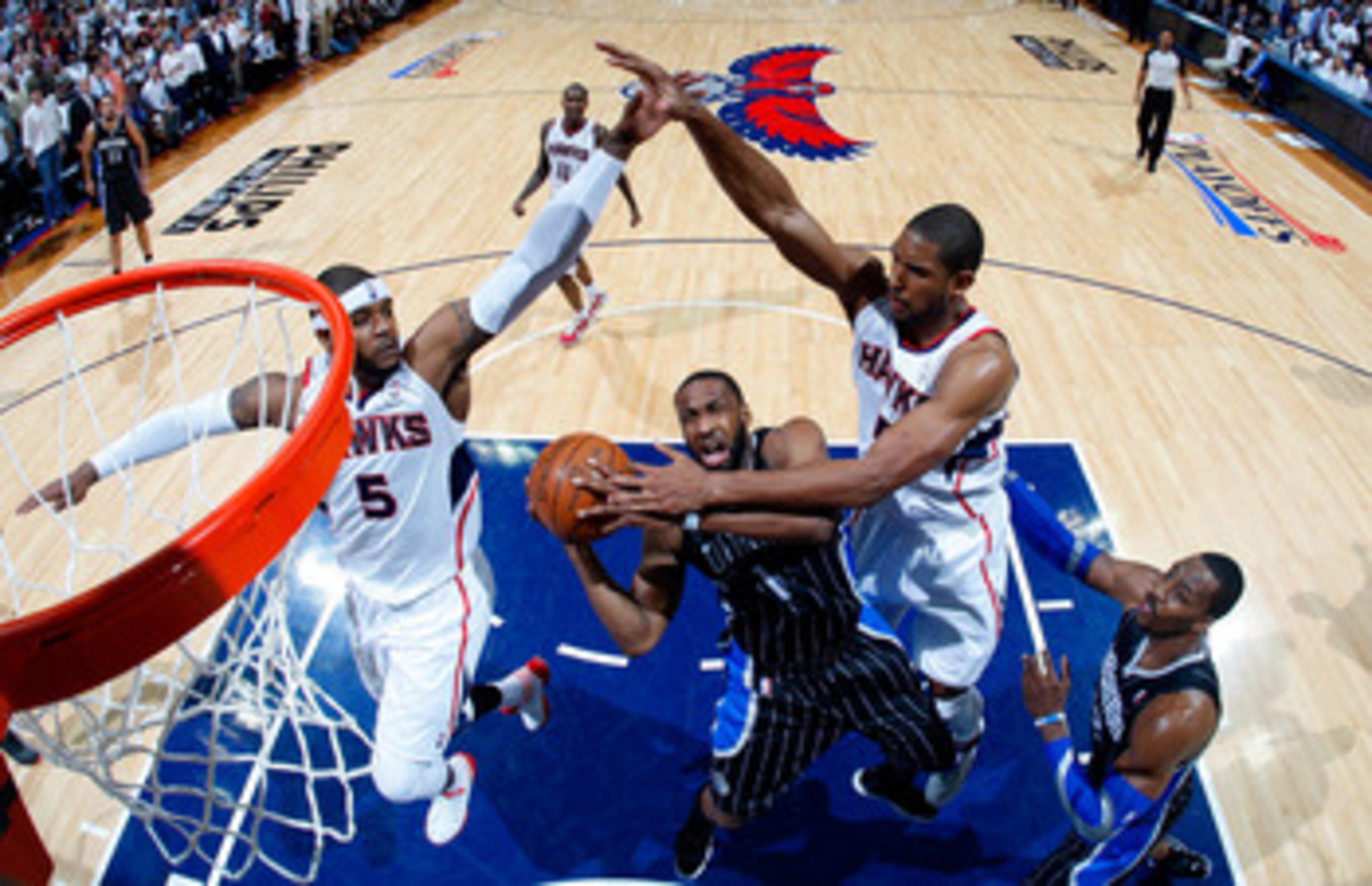 ATLANTA, GA - APRIL 28:  Gilbert Arenas #1 of the Orlando Magic drives to the basket against Josh Smith #5 and Al Horford #15 of the Atlanta Hawks during Game Six of the Eastern Conference Quarterfinals in the 2011 NBA Playoffs at Philips Arena on April 2