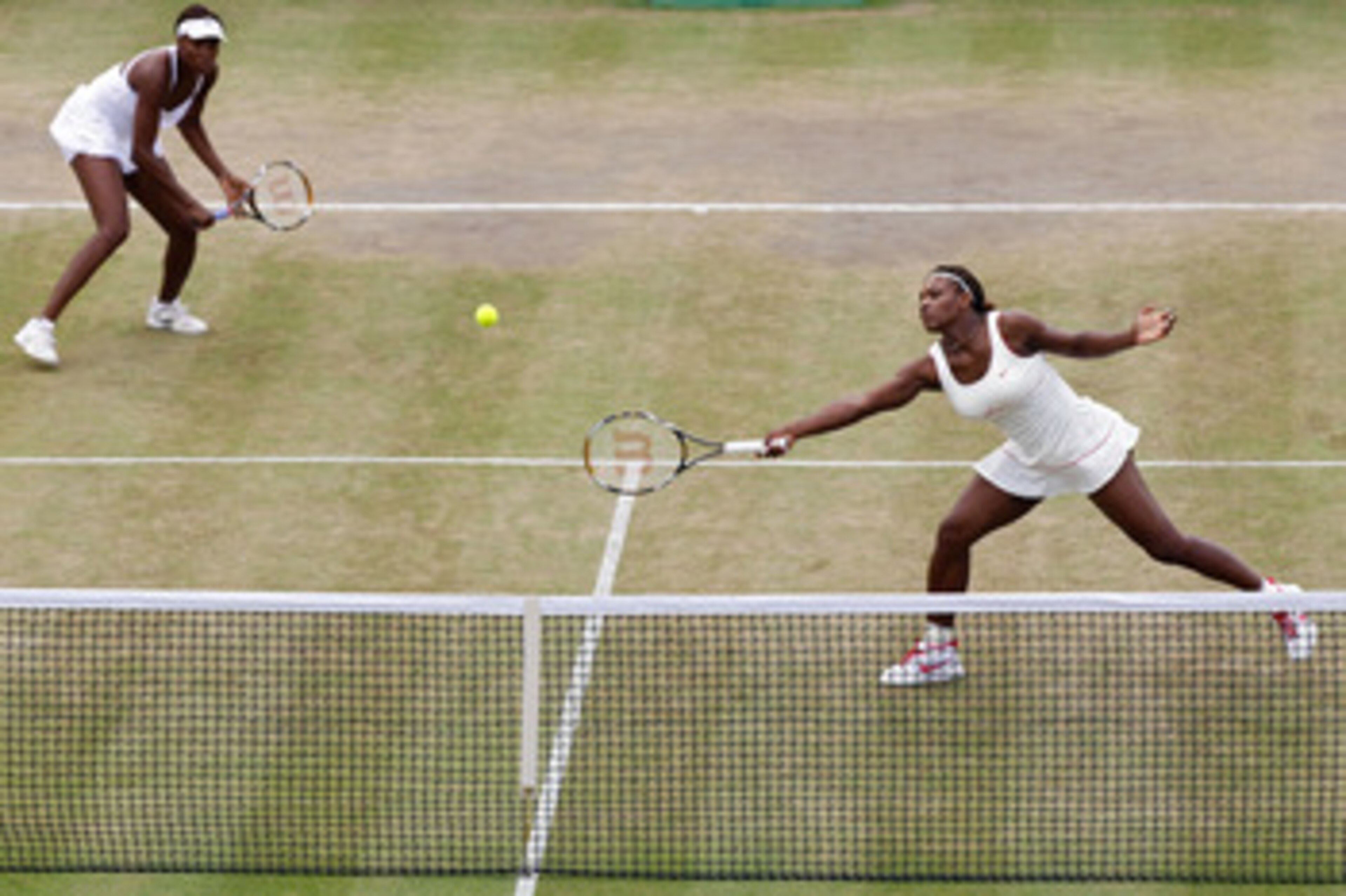 LONDON, ENGLAND - JUNE 30: Serena Williams (R) and Venus Williams of USA in action during their Quarter Final doubles match against Elena Vesnina and Vera Zvonareva of Russia on Day Nine of the Wimbledon Lawn Tennis Championships at the All England Lawn LONDON, ENGLAND - JUNE 30: Serena Williams (R) and Venus Williams of USA in action during their Quarter Final doubles match against Elena Vesnina and Vera Zvonareva of Russia on Day Nine of the Wimbledon Lawn Tennis Championships at the All England Lawn