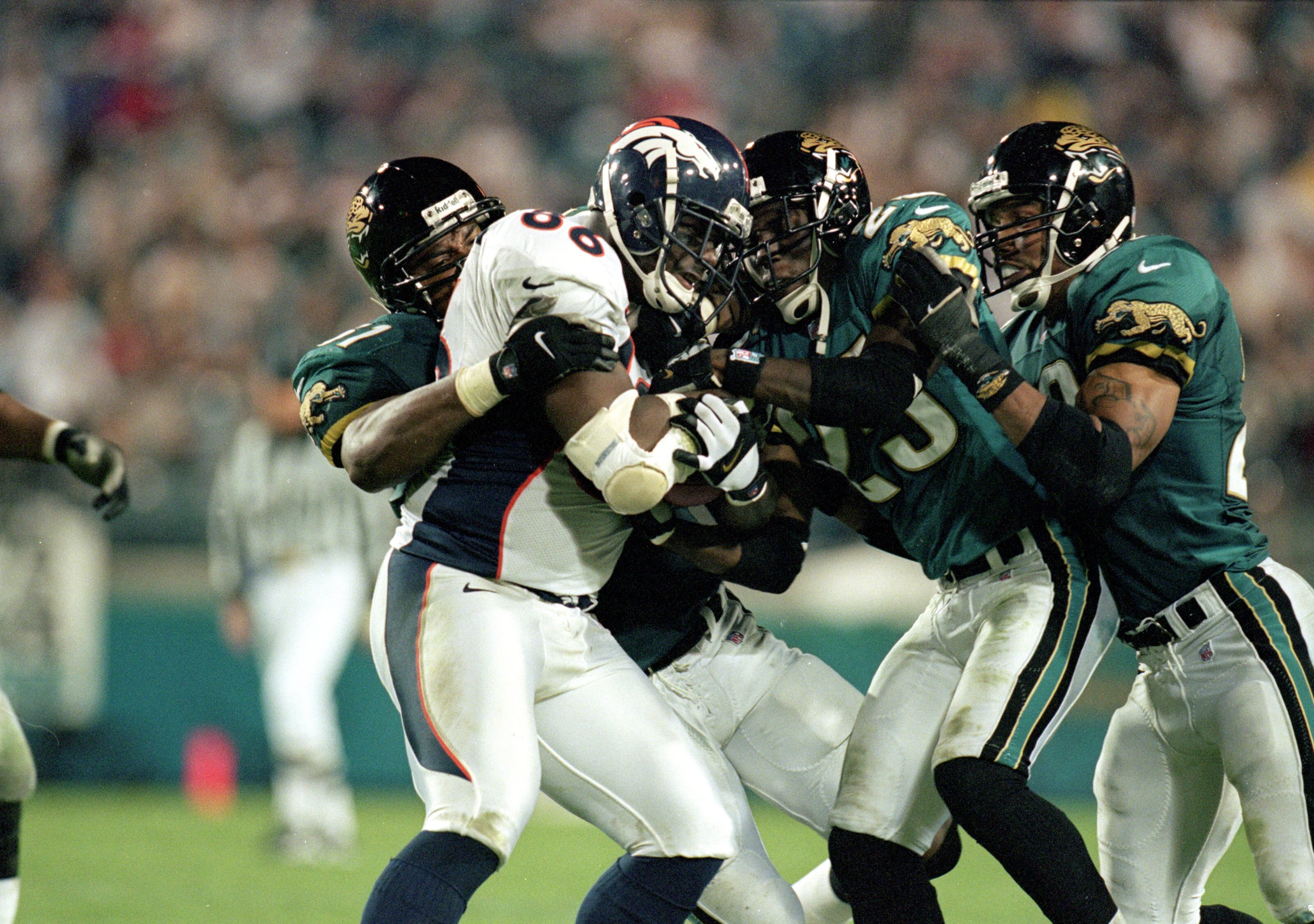 13 Dec 1999:  Byron Chamberlain #86 of the Denver Broncos carries the ball as he is tackled by  Jacksonville Jaguars at the Altell Stadium in Jacksonville, Florida. The Jaguars defeated the Broncos 27-24. Mandatory Credit: Andy Lyons  /Allsport