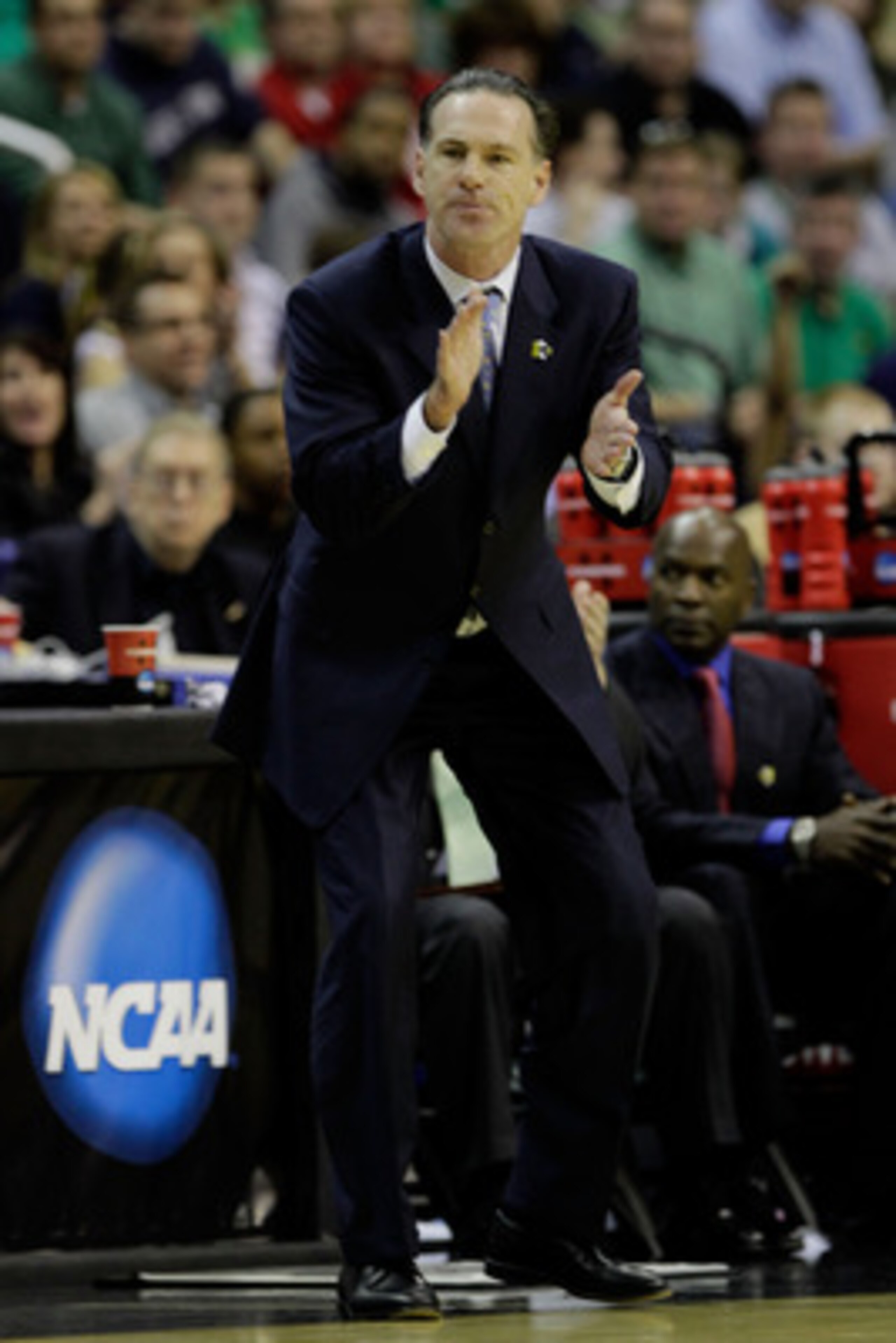 WASHINGTON - MARCH 17: Head coach of the Pittsburgh Panthers Jamie Dixon, shouts from the bench during their game against the North Carolina-Asheville Bulldogs during the second round of the 2011 NCAA men's basketball tournament at the Verizon Center on WASHINGTON - MARCH 17: Head coach of the Pittsburgh Panthers Jamie Dixon, shouts from the bench during their game against the North Carolina-Asheville Bulldogs during the second round of the 2011 NCAA men's basketball tournament at the Verizon Center on