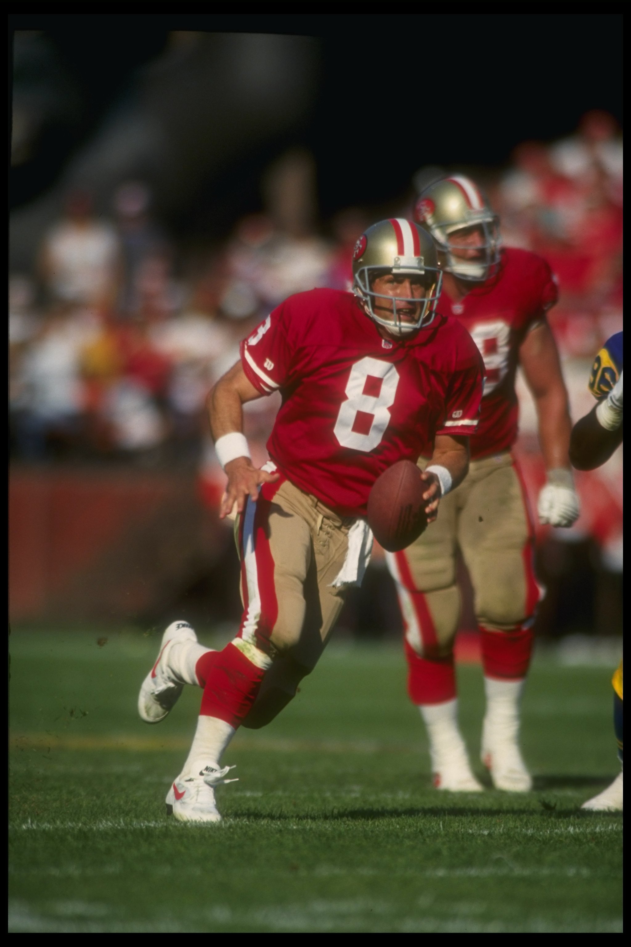 4 Oct 1992:  Quarterback Steve Young of the San Francisco 49ers runs with the ball during a game against the Los Angeles Rams at Candlestick Park in San Francisco, California.  The 49ers won the game, 40-17. Mandatory Credit: Otto Greule  /Allsport
