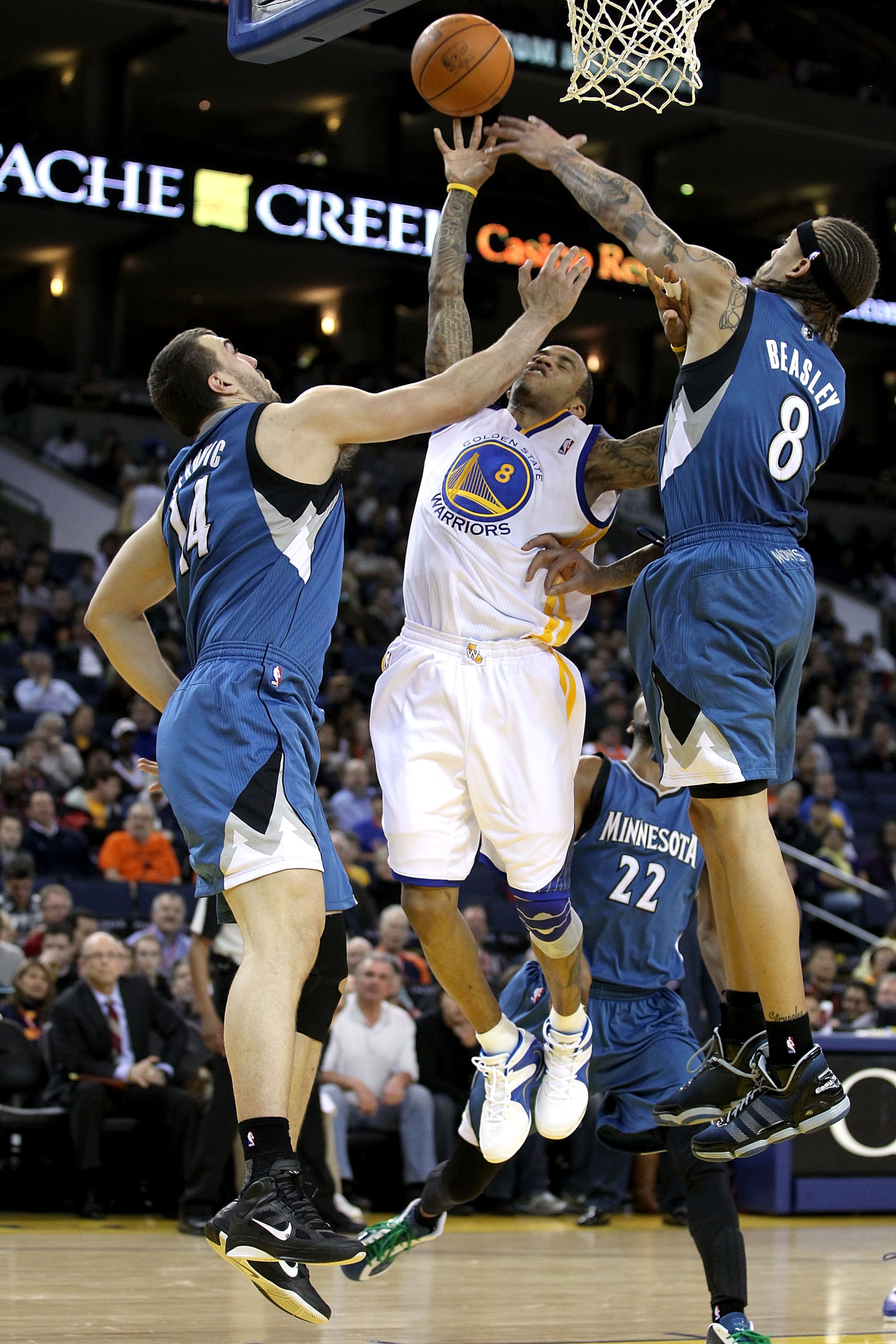 OAKLAND, CA - DECEMBER 14:  Nikola Pekovic #14 and Michael Beasley #8 of the Minnesota Timberwolves defend against Monta Ellis #8 of the Golden State Warriors at Oracle Arena on December 14, 2010 in Oakland, California.  NOTE TO USER: User expressly ackno