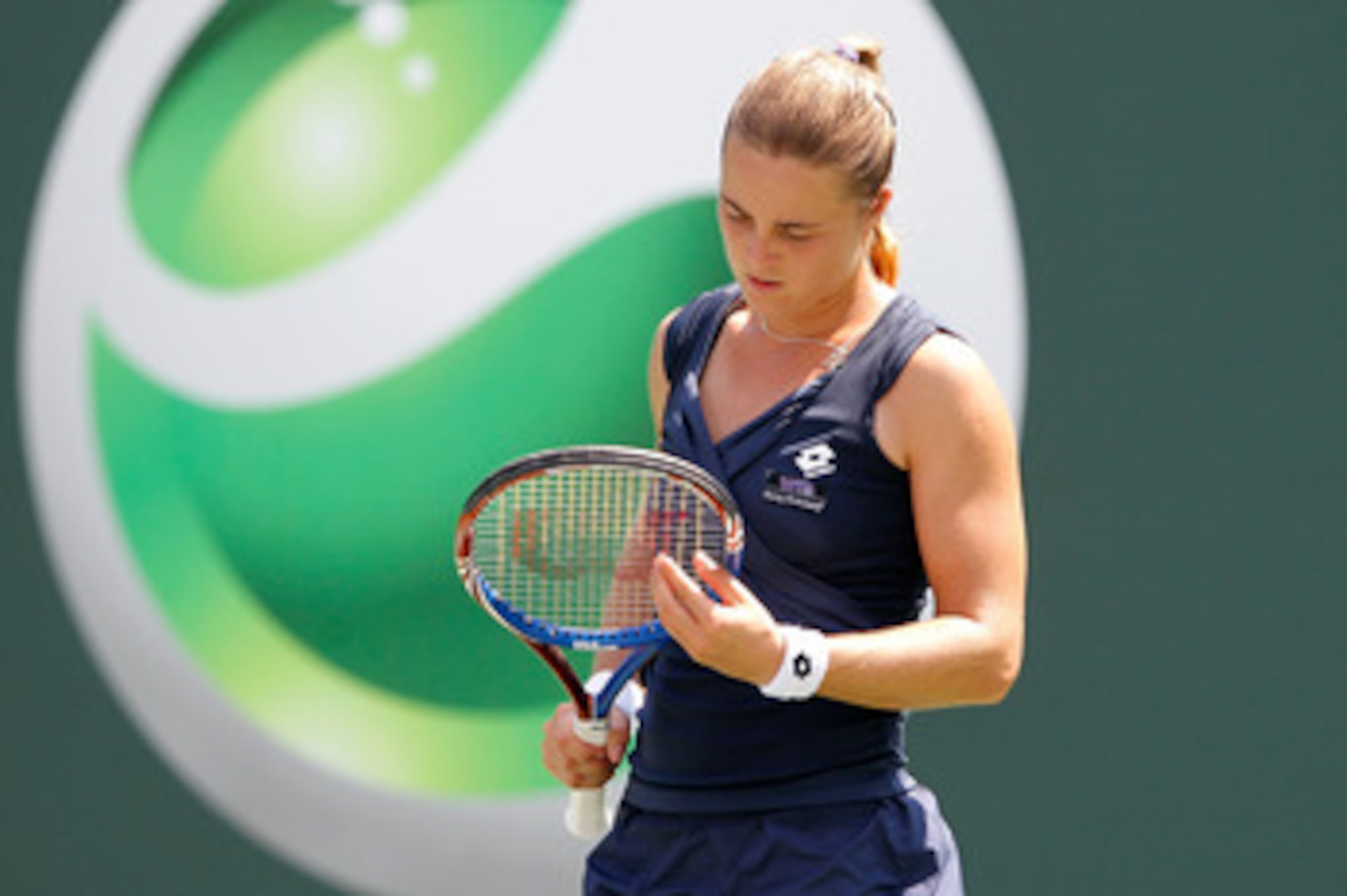 KEY BISCAYNE, FL - MARCH 25:  Anastasiya Yakimova of Belarus inspects her racquet against Kim Clijsters of Belgium during the Sony Ericsson Open at Crandon Park Tennis Center on March 25, 2011 in Key Biscayne, Florida.  (Photo by Matthew Stockman/Getty Im