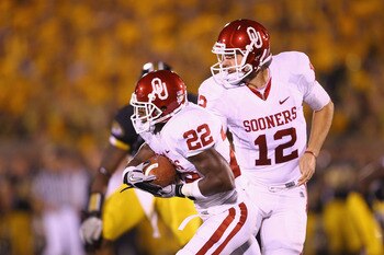 COLUMBIA, MO - OCTOBER 23: Landry Jones #12 of the Oklahoma Sooners hands the ball off to Roy Finch #22 also of the Oklahoma Sooners at Faurot Field/Memorial Stadium on October 23, 2010 in Columbia, Missouri.  The Tigers beat the Sooners 36-27.  (Photo by