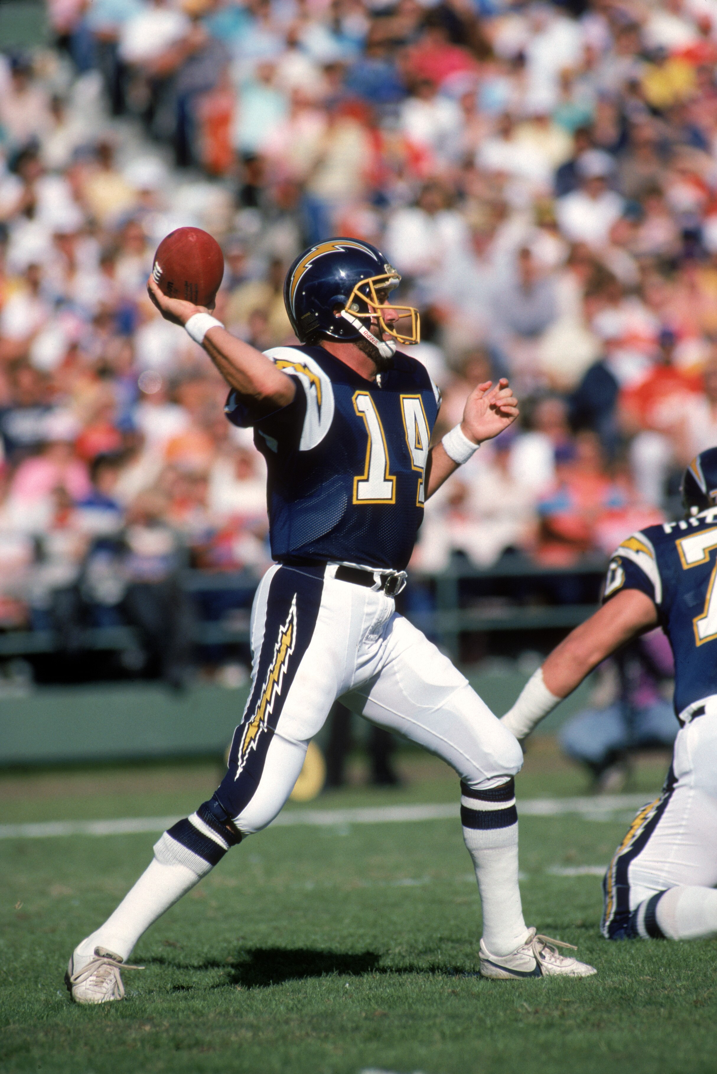 SAN DIEGO - NOVEMBER 29:  Quarterback Dan Fouts #14 of the San Diego Chargers throws a pass during a game against the Denver Broncos at Jack Murphy Stadium on November 29, 1987 in San Diego, California.  Fouts completed 23 out of 48 passes for 322 yards a