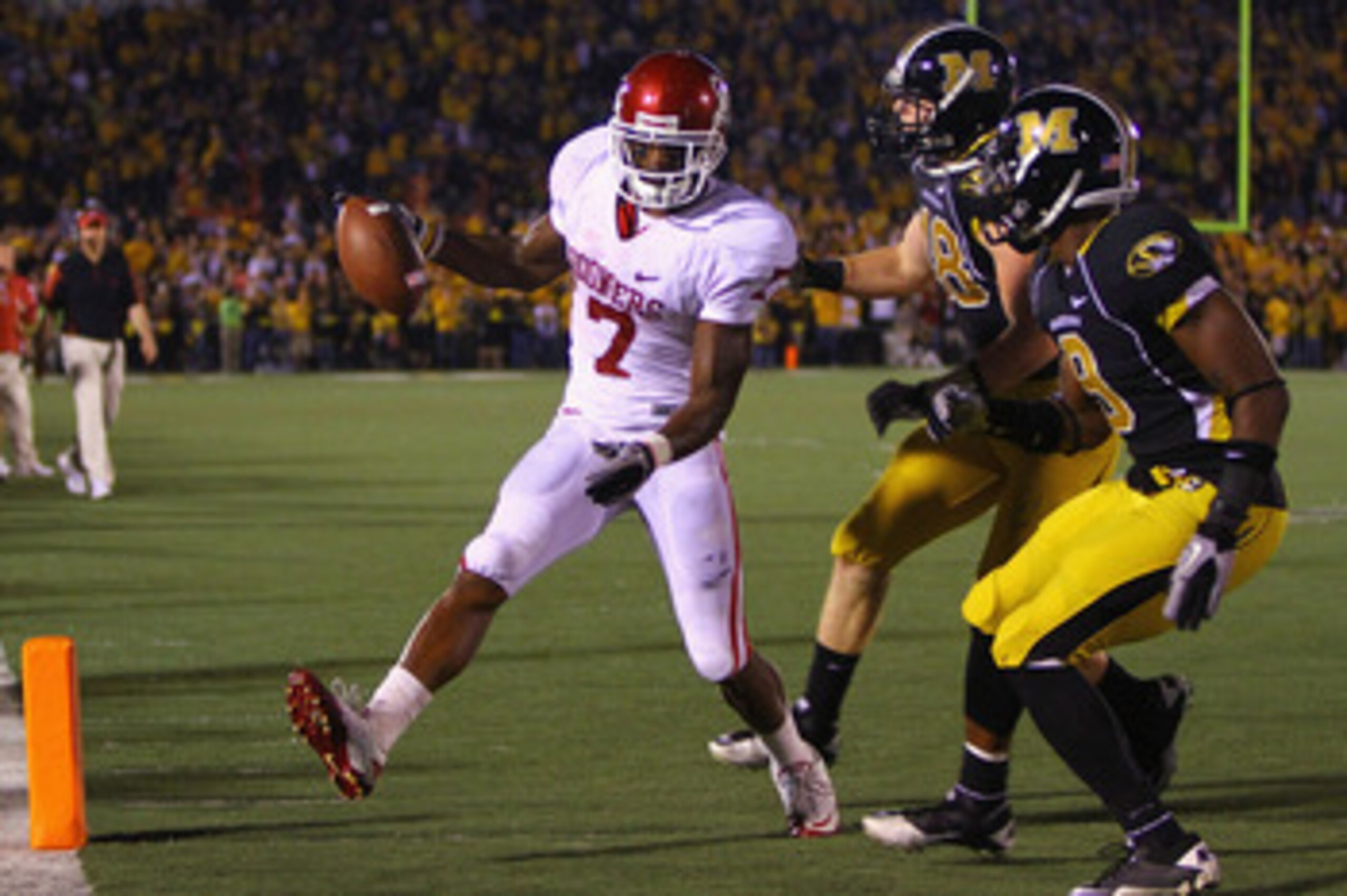 COLUMBIA, MISSOURI - OCTOBER 23: DeMarco Murray #7 of the Oklahoma Sooners scores a touchdown against Marcus Malbrough #18 and Jasper Simmons #9 both of the Missouri Tigers at Faurot Field/Memorial Stadium on October 23, 2010 in Columbia, Missouri.  (Phot