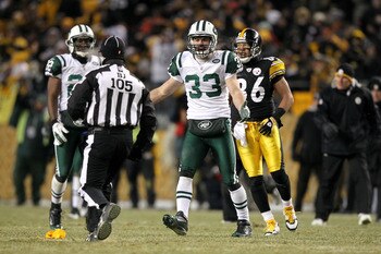 PITTSBURGH, PA - JANUARY 23:  Eric Smith #33 of the New York Jets argues with back judge Dino Paganelli #105 against the Pittsburgh Steelersduring the 2011 AFC Championship game at Heinz Field on January 23, 2011 in Pittsburgh, Pennsylvania.  (Photo by Al