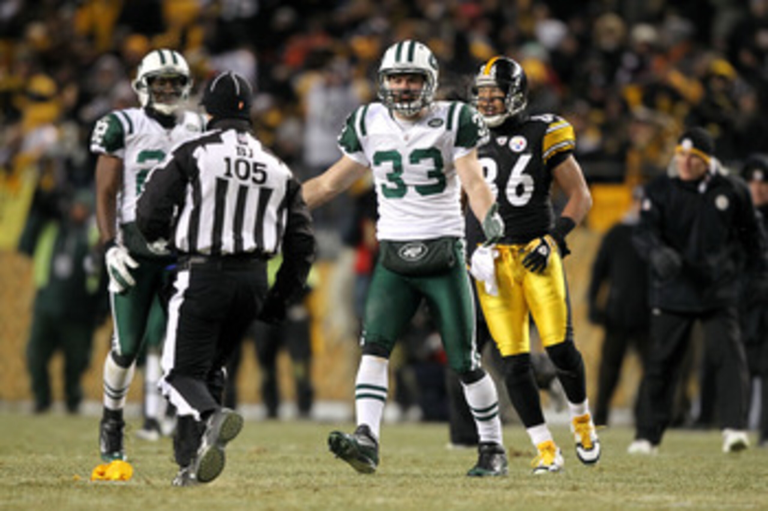 PITTSBURGH, PA - JANUARY 23:  Eric Smith #33 of the New York Jets argues with back judge Dino Paganelli #105 against the Pittsburgh Steelersduring the 2011 AFC Championship game at Heinz Field on January 23, 2011 in Pittsburgh, Pennsylvania.  (Photo by Al