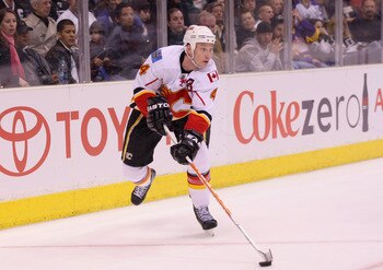 LOS ANGELES, CA - MARCH 21:  Jay Bouwmeester #4 of the Calgary Flames moves the puck around the net during their NHL game against the Los Angeles Kings at Staples Center on March 21, 2011 in Los Angeles, California. The Kings defeated the Flames 2-1 in sh