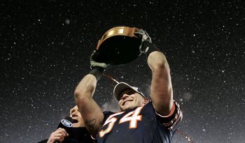 CHICAGO - JANUARY 21:  Brian Urlacher of the Chicago Bears holds up the George S. Halas trophy as he celebrates the Bears 39-14 win against the New Orleans Saints during the NFC Championship Game January 21, 2007 at Soldier Field in Chicago, Illinois.  (P