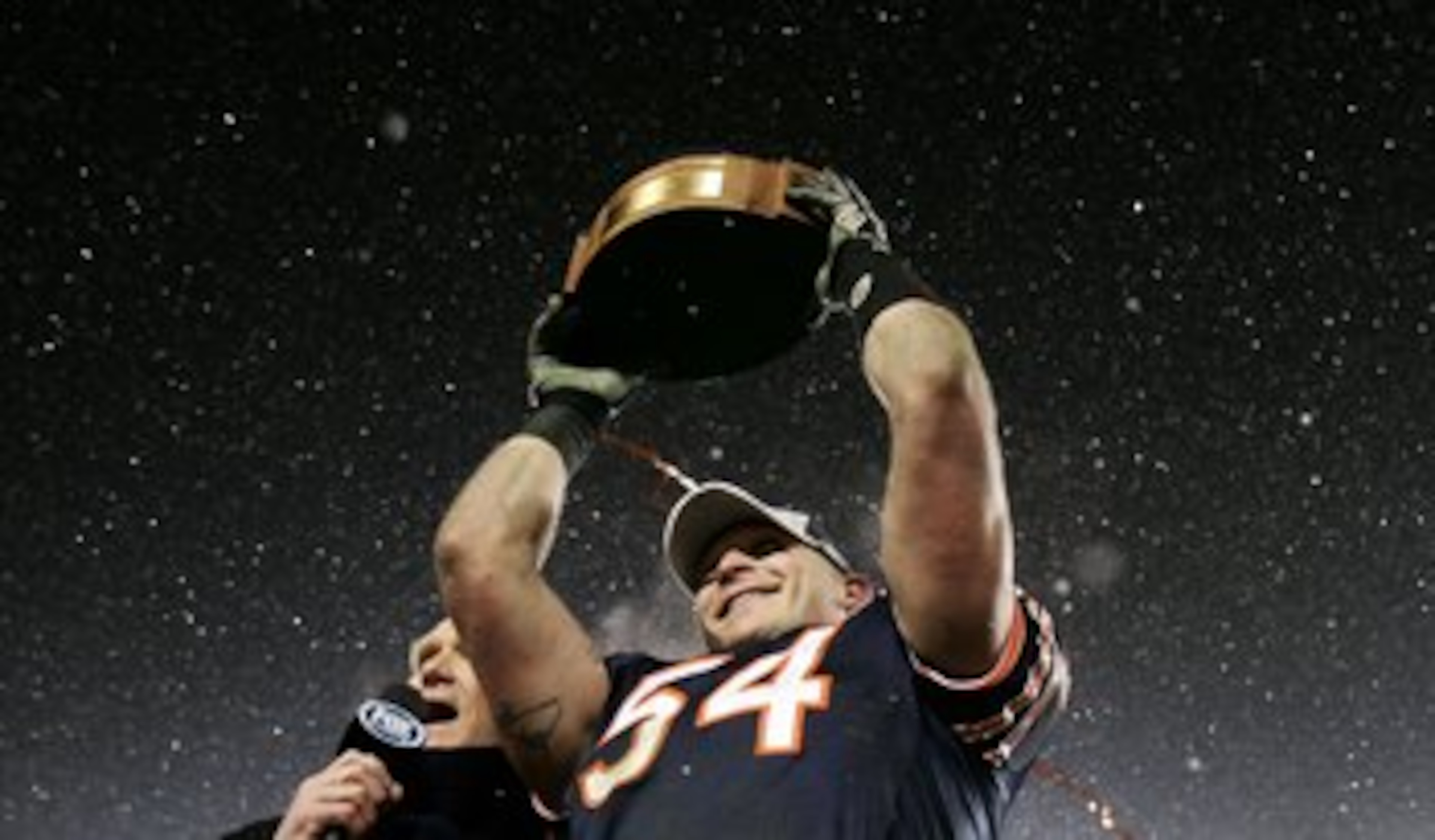 CHICAGO - JANUARY 21:  Brian Urlacher of the Chicago Bears holds up the George S. Halas trophy as he celebrates the Bears 39-14 win against the New Orleans Saints during the NFC Championship Game January 21, 2007 at Soldier Field in Chicago, Illinois.  (P