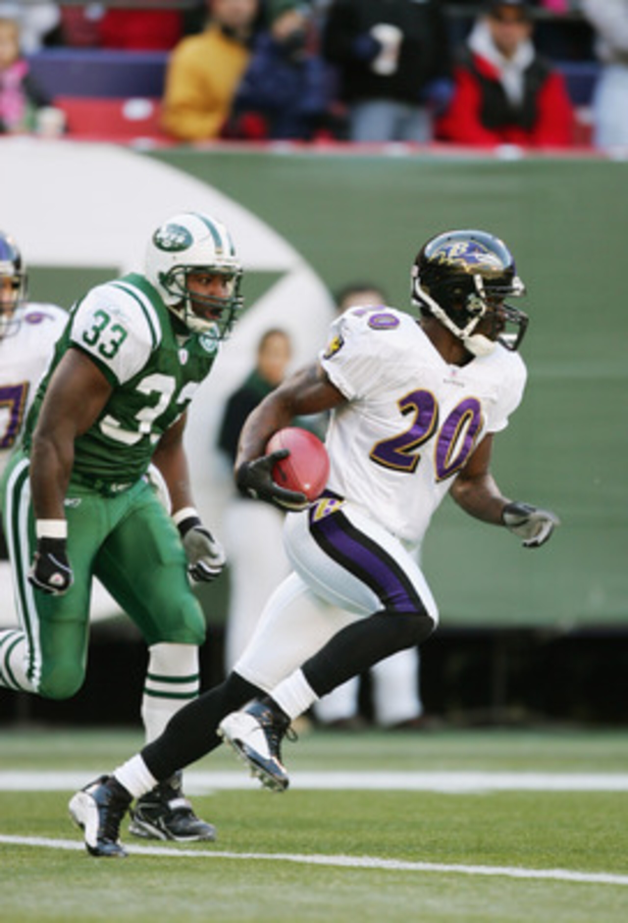 EAST RUTHERFORD, NJ - NOVEMBER 14:  Safety Ed Reed #20 of the Baltimore Ravens runs with the ball ahead of Jerald Sowell #33 of the New York Jets during their game on November 14, 2004 at Giants Stadium in East Rutherford, New Jersey. The Ravens defeated