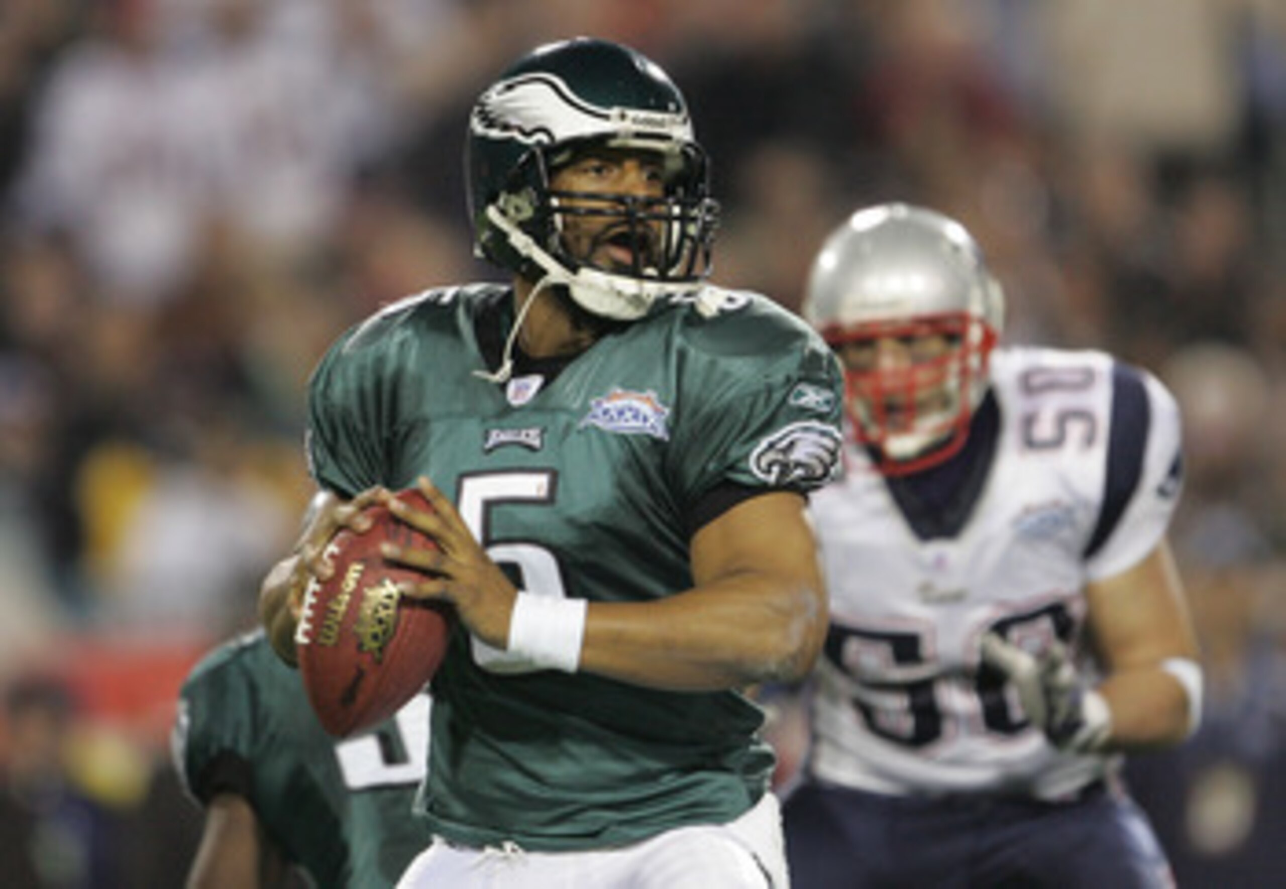 JACKSONVILLE, FLORIDA - FEBRUARY 06:  Quarterback Donovan McNabb #5 of the Philadelphia Eagles drops back for a pass against the defense of the New England Patriots trys to stop him during the first quarter of Super Bowl XXXIX at Alltel Stadium on Februar
