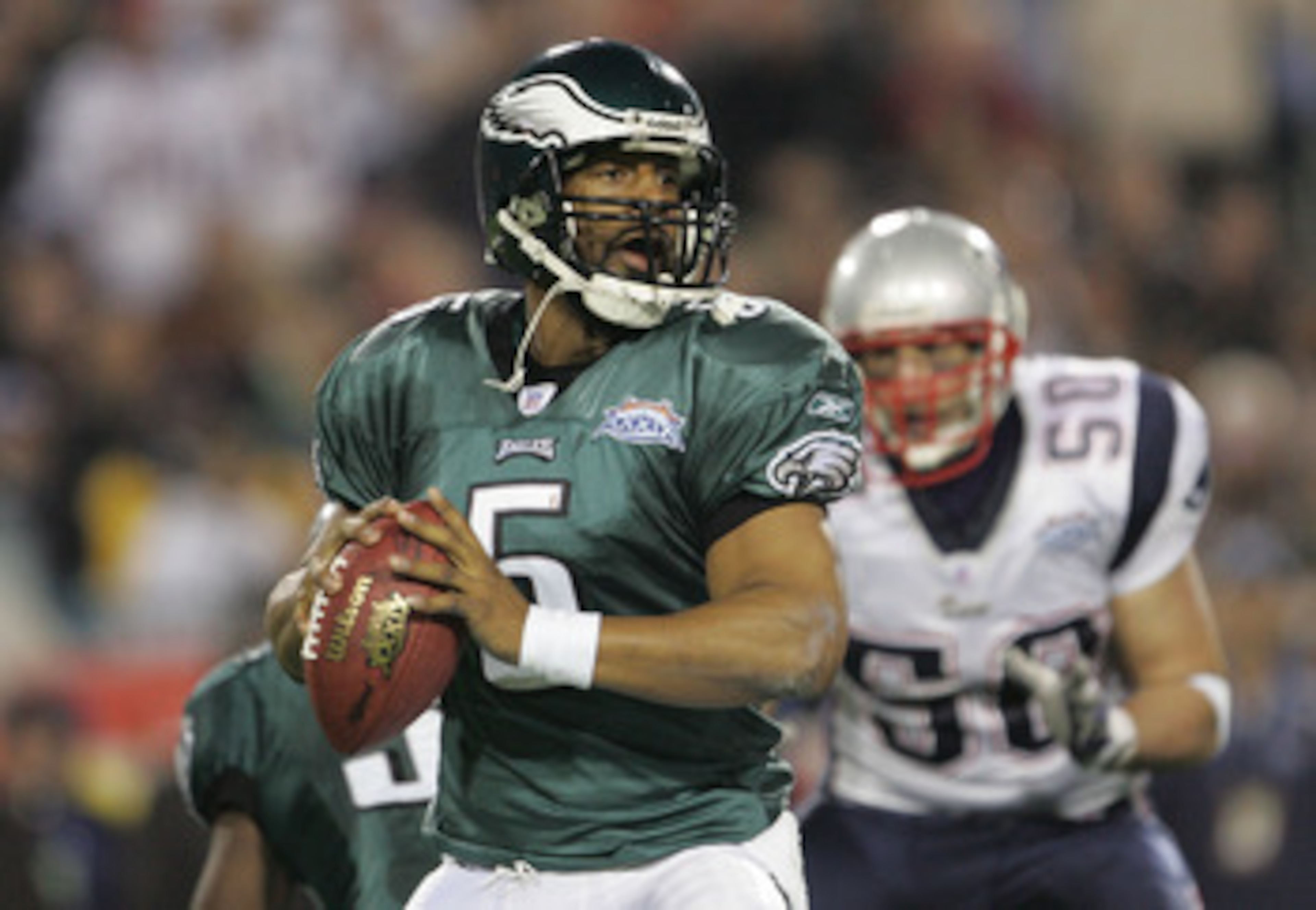 JACKSONVILLE, FLORIDA - FEBRUARY 06:  Quarterback Donovan McNabb #5 of the Philadelphia Eagles drops back for a pass against the defense of the New England Patriots trys to stop him during the first quarter of Super Bowl XXXIX at Alltel Stadium on Februar